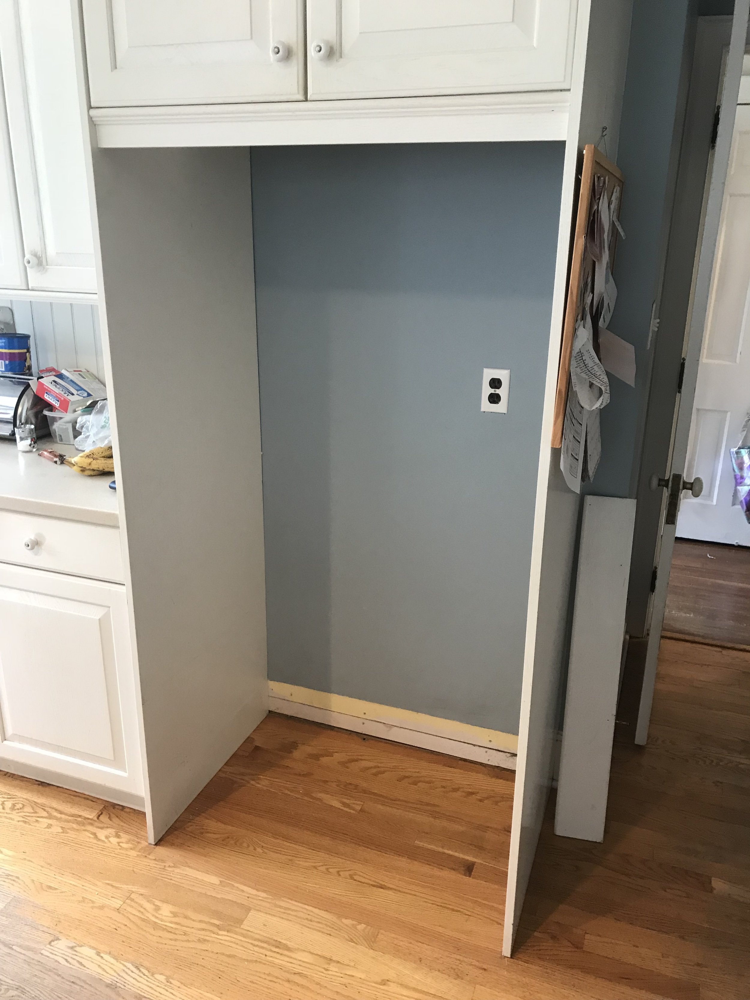  A client contacted me about installing some pull out shelving and cabinet doors with blackboard panels in this cabinet where their refrigerator had been previously.  