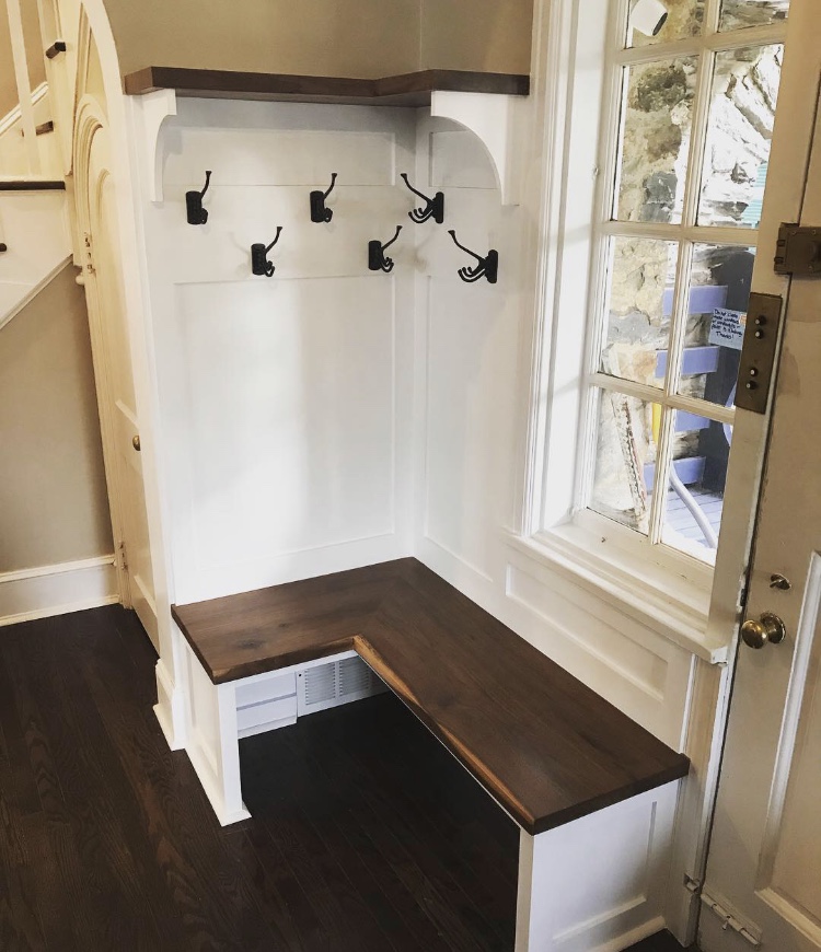  This is the finished built in. The space was too small for traditional lockers, so multi-tiered swiveling hooks were installed to maximize storage, and the area under the bench was also left as open as possible for the same reason. 