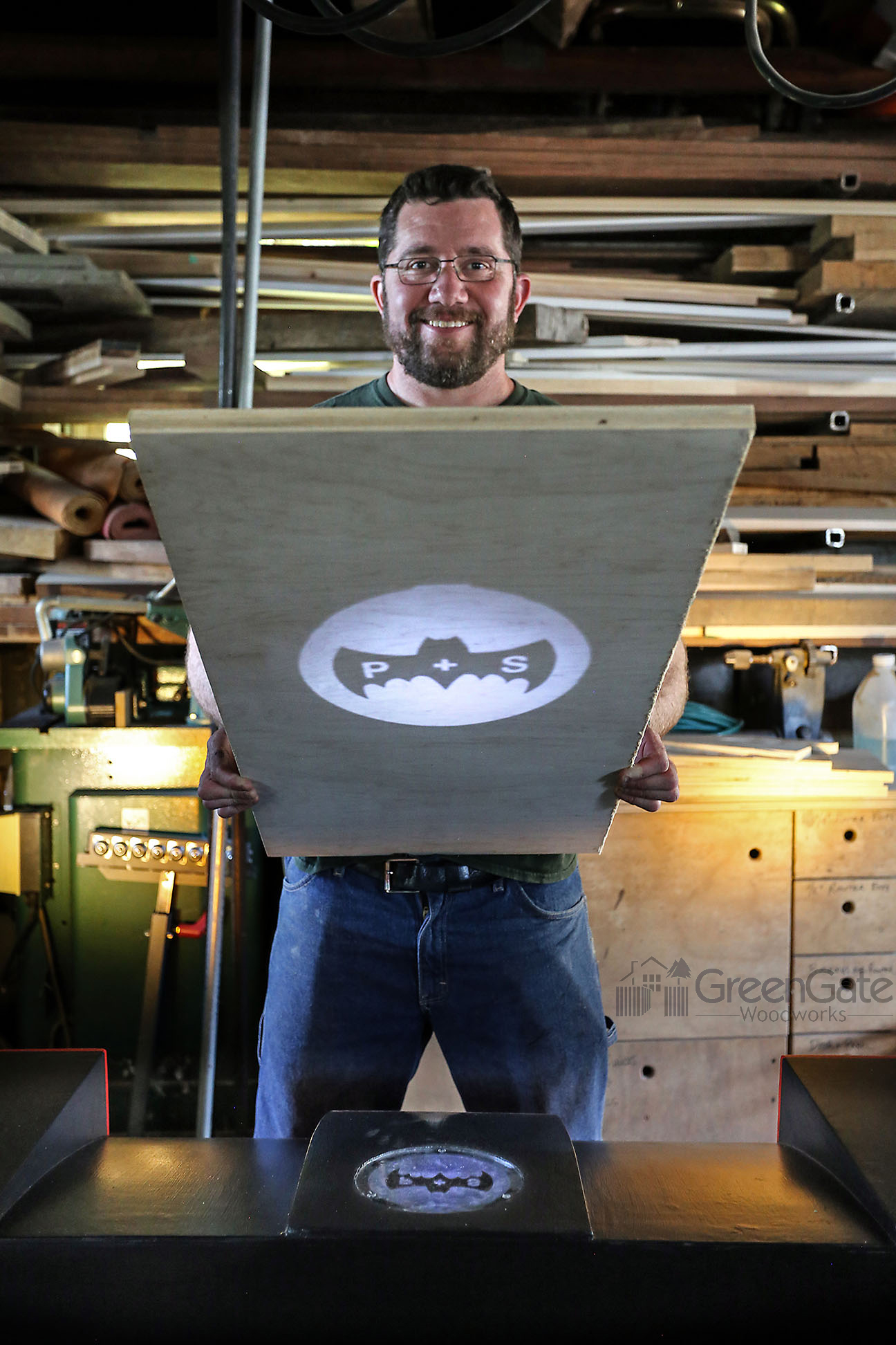 Me, holding a piece of plywood to demonstrate the Bat-signal in action.