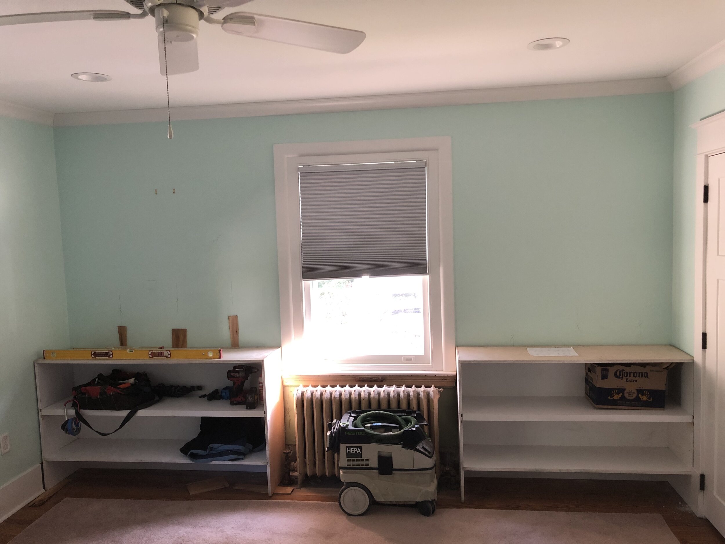 While I was building  these  living room built-ins, the client asked me to also make a set for their master bedroom to provide additional storage for their extensive book collection. Originally this wall was blank except for a dated radiator cover. 