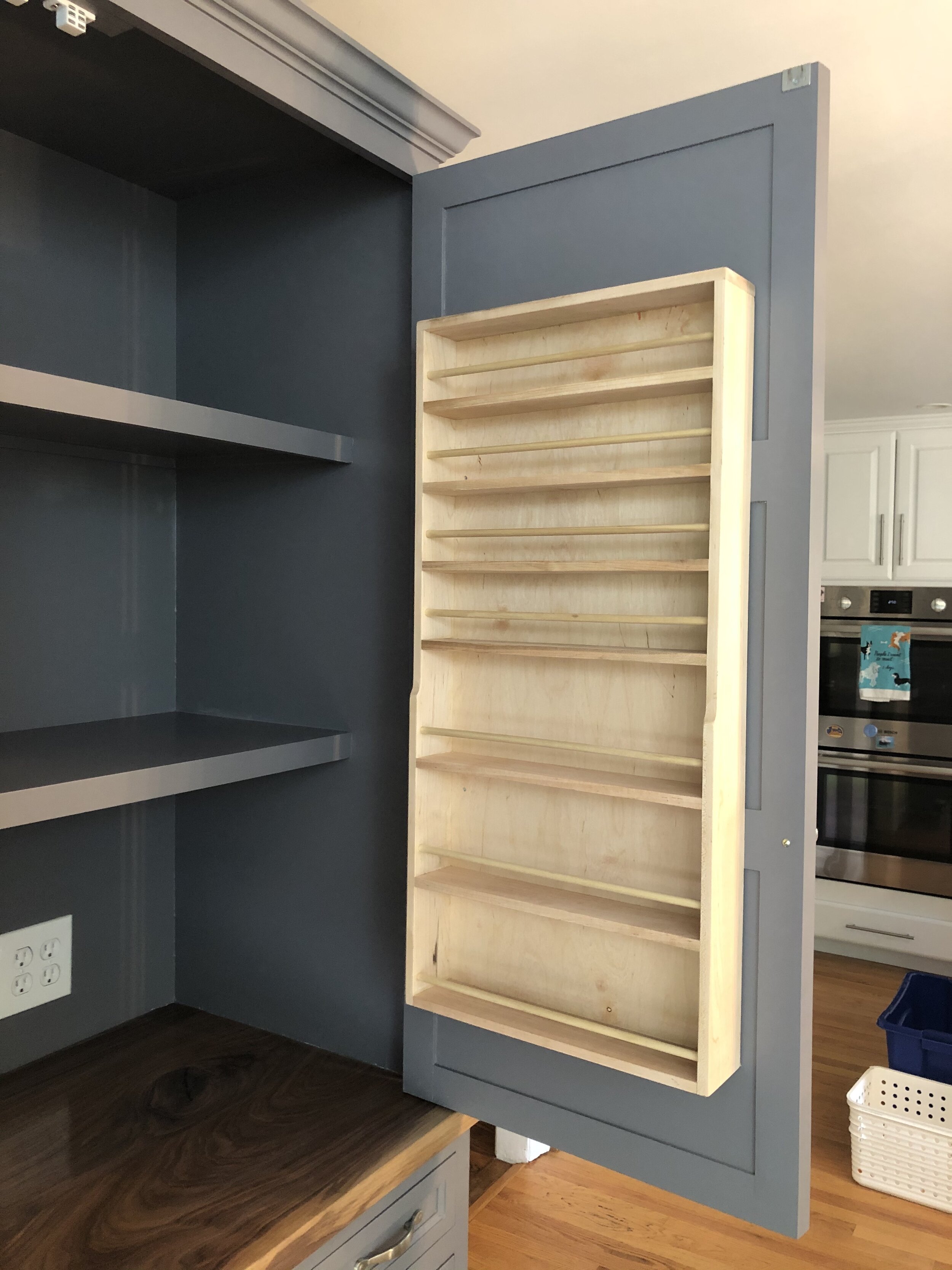  The spice racks are made primarily from maple with 3/8” dowels in front of each shelf. The four upper shelves are designed to hold small spice jars, while the three lower shelves are set up to accommodate larger ones. 