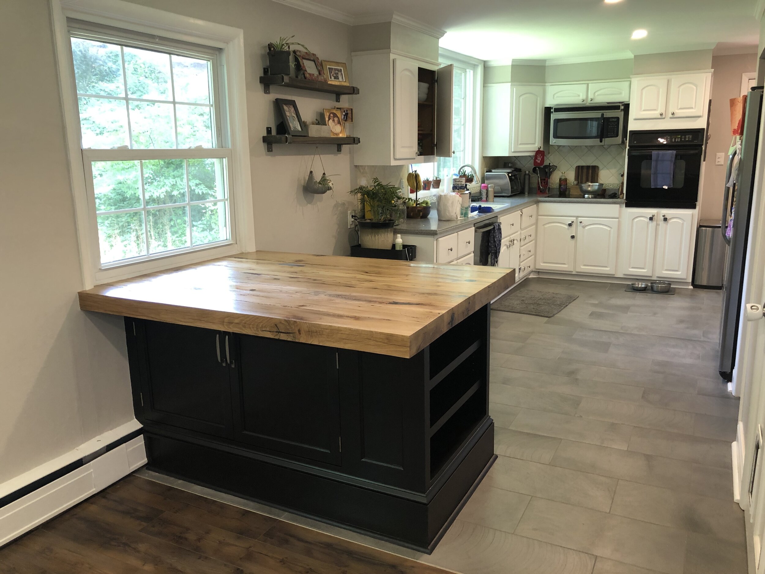  The peninsula installed. The base cabinet is painted a satin black and has bookshelves on one end for cookbooks, etc.  