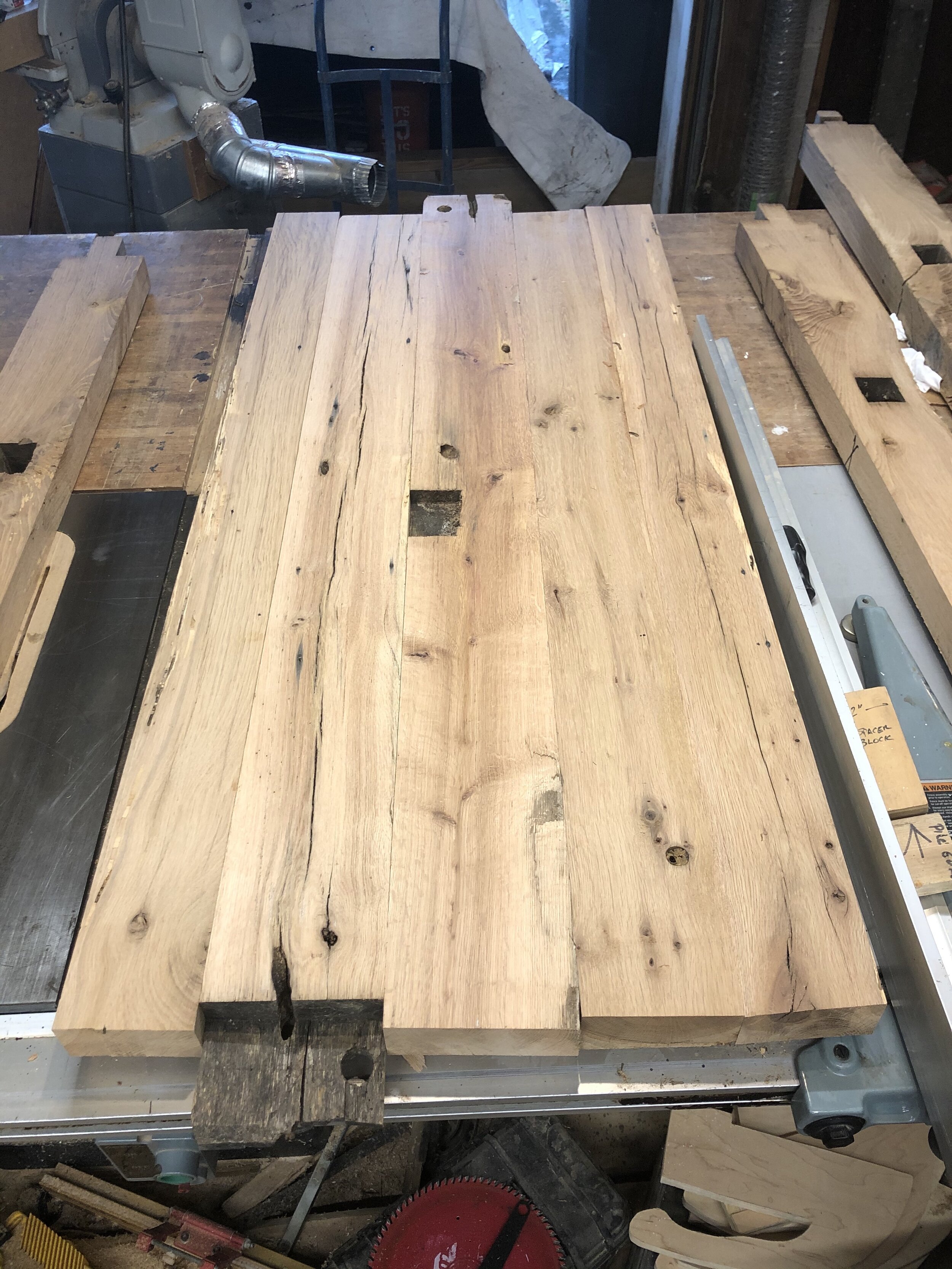  I began by milling several of the beams I had at my shop and then arranging the boards for the new countertops. The clients wanted to highlight the mortise pockets in the wood from the original beams, so I tried several different arrangements of the