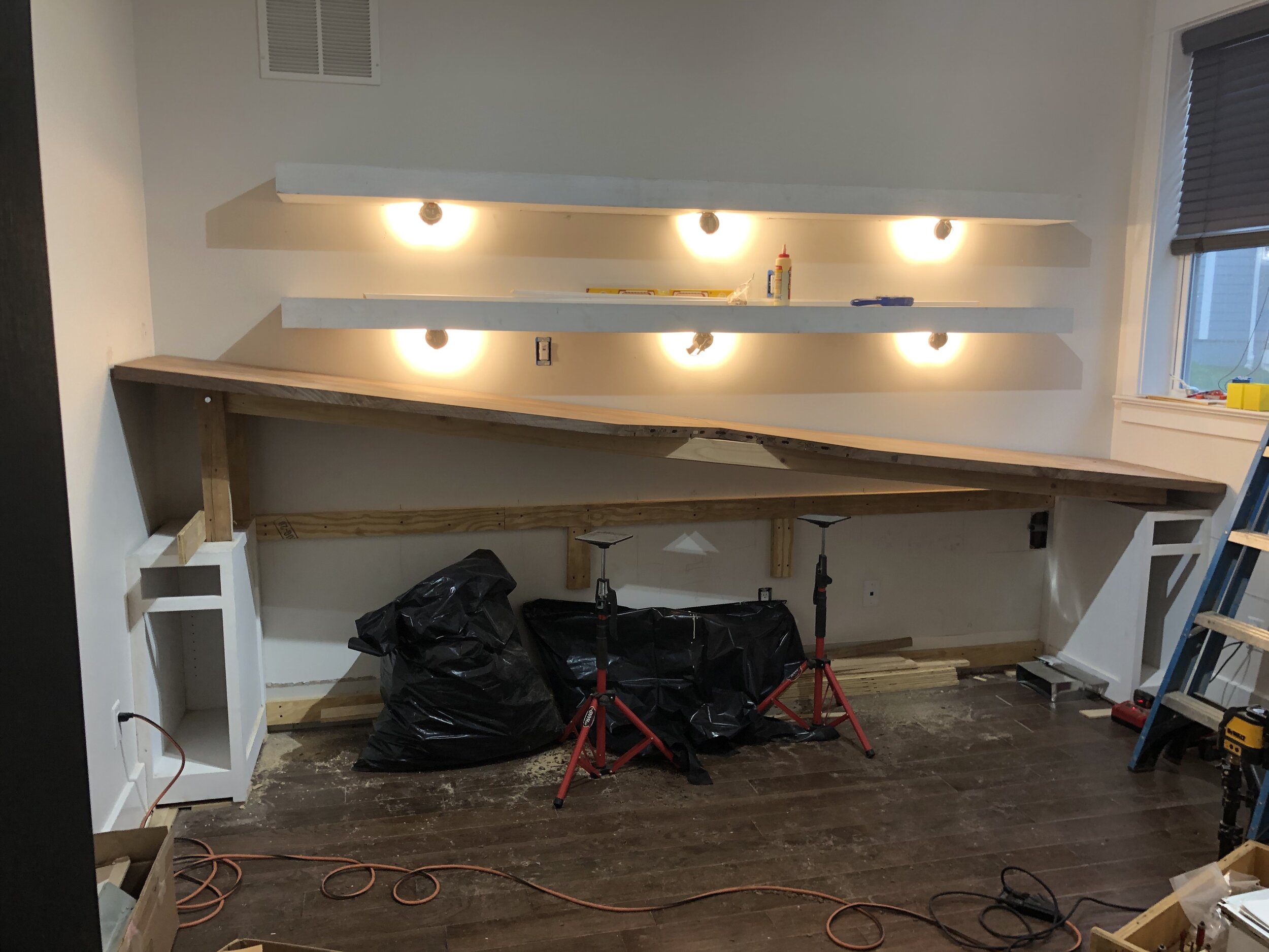  Once I had the desktop sections shaped and dry-fit in my shop, it was time to install them. The first two sections would go along the wall, with the third coming in at a 90 degree angle to create the T-shaped desktop. In order to install it safely b