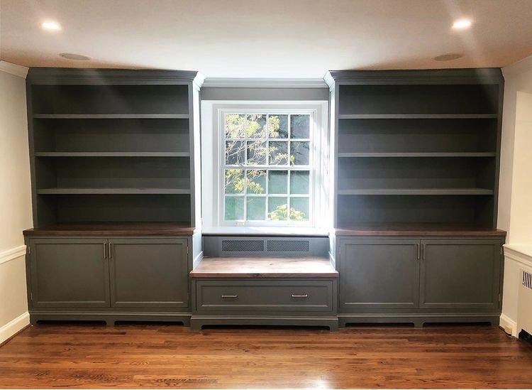  Here are the finished built-ins. They feature inset doors, lifted baseboards, and black walnut countertops and bench top. A large single drawer under the window seat provide additional storage.  