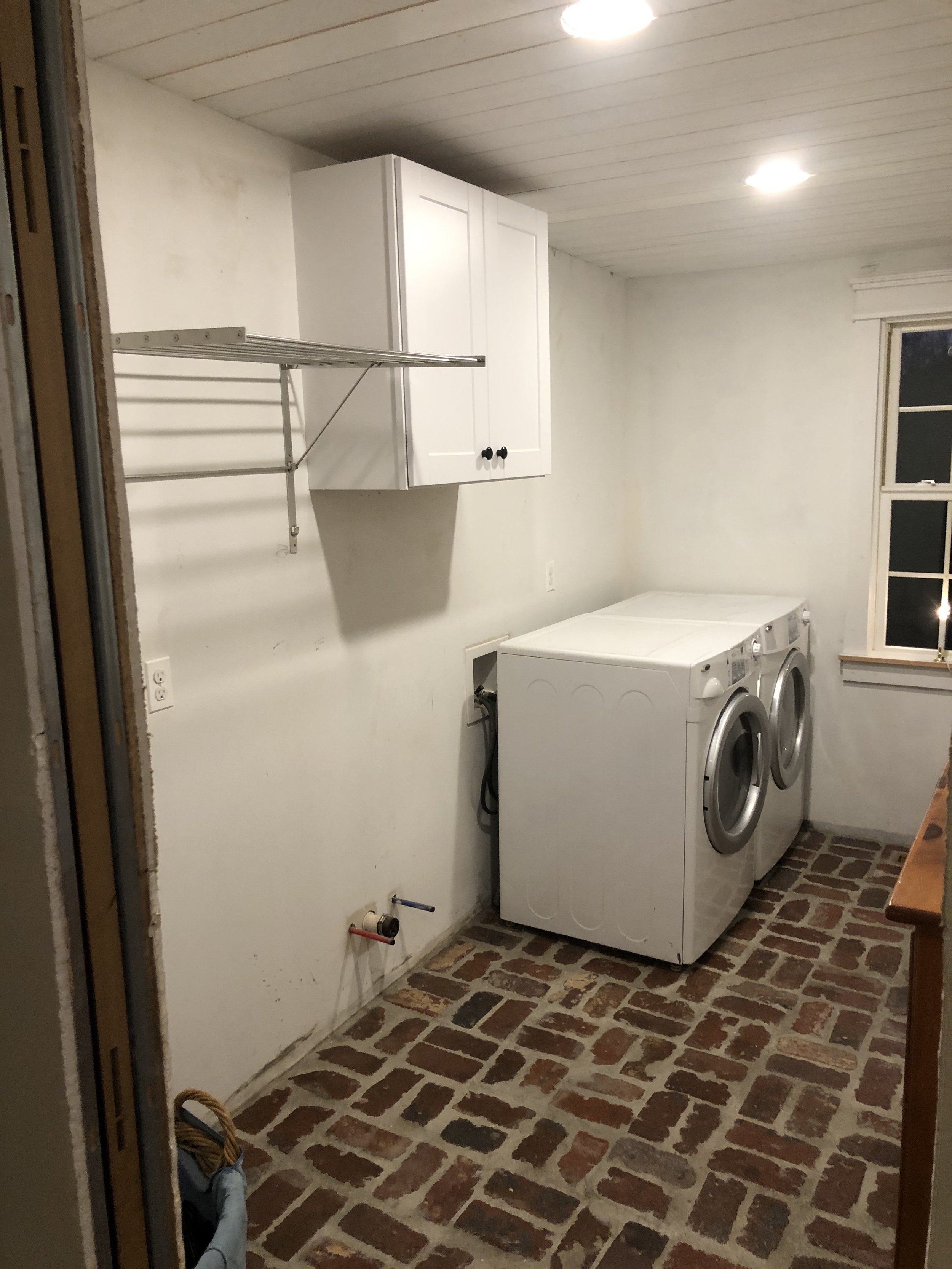  With the brick floors and ceiling done for the time being, I moved the washer and dryer back into the room while I worked on the final cabinet design.  