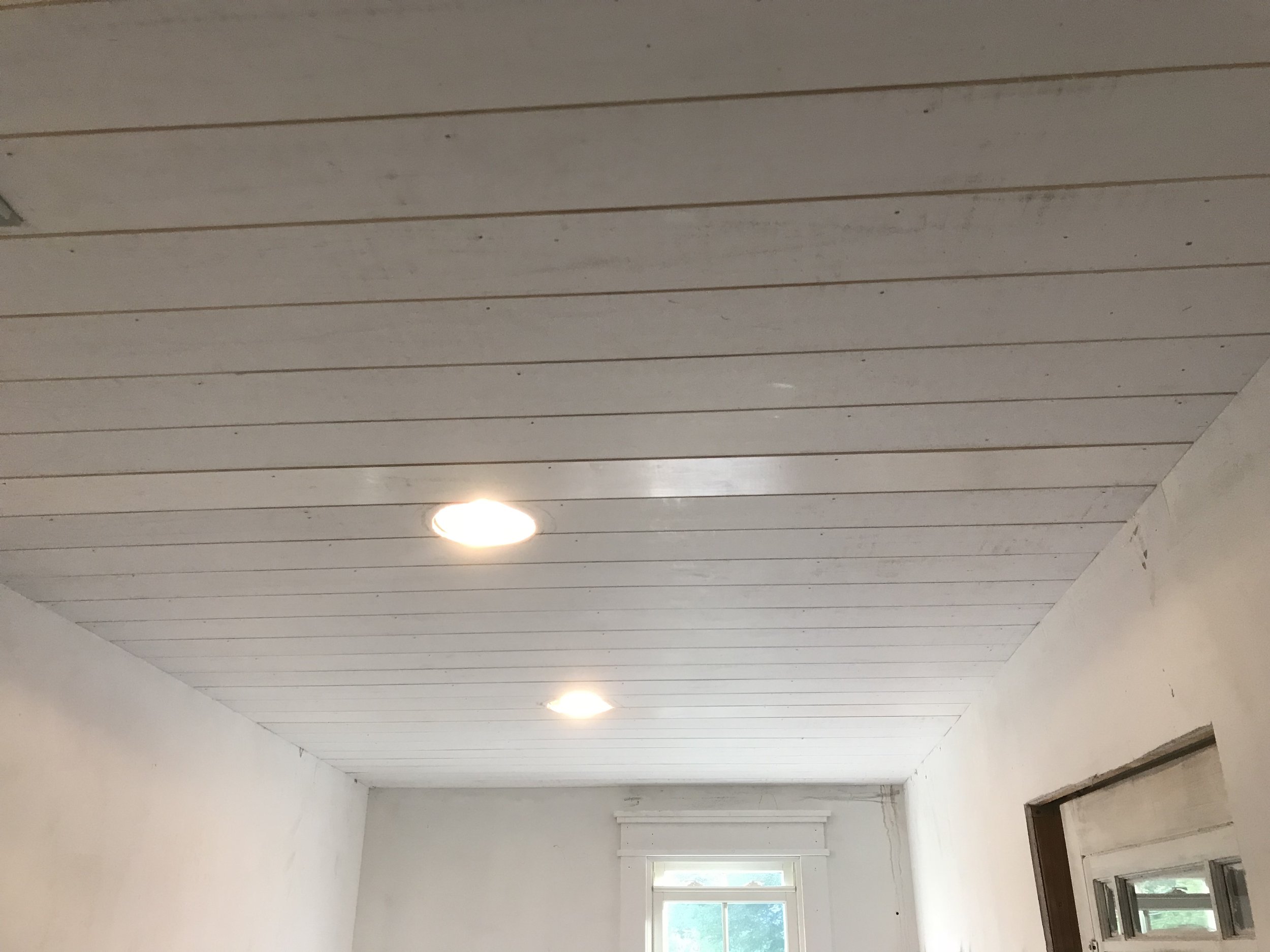  After the floors were in, I added a wainscot ceiling. This portion of our home was original a porch, and we decided to maintain that character when we renovated, hence the brick floors and this ceiling.  