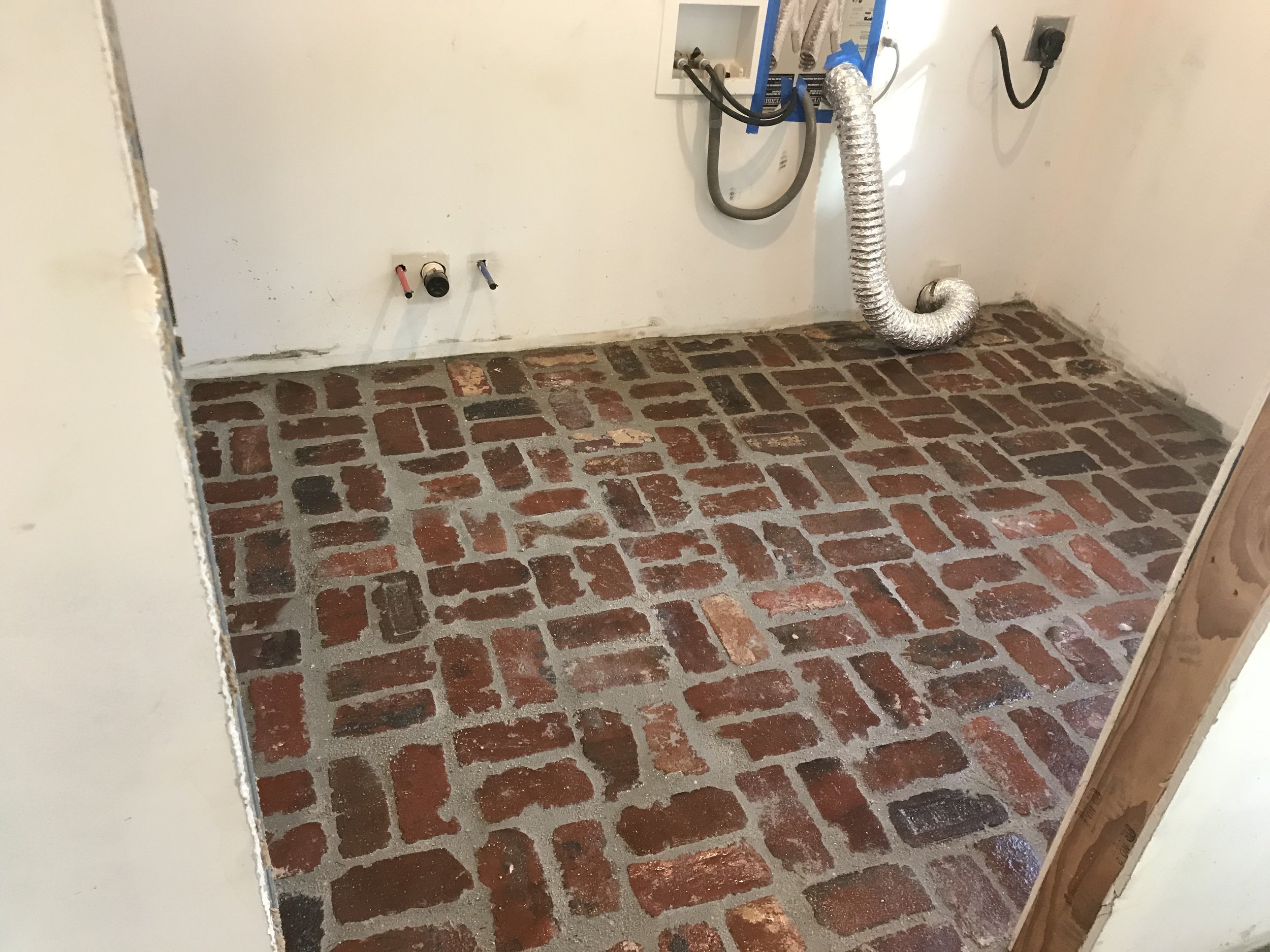  After the bricks were installed, I sealed the bricks, then grouted everything. This protected the bricks from getting stained by the grout. Once the grout was cleaned up, I applied multiple additional layers of sealant to the entire floor.  