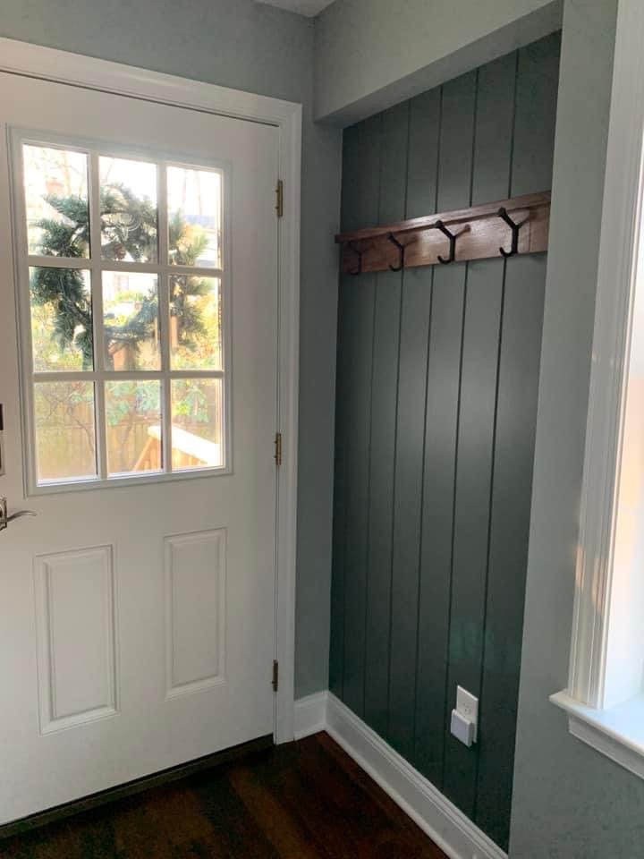 The recessed alcove on the opposing wall has the same railroad spike hooks, and a black walnut shelf and custom-made wainscoting to match the built-ins. Photo credit: Melanie Lemke 