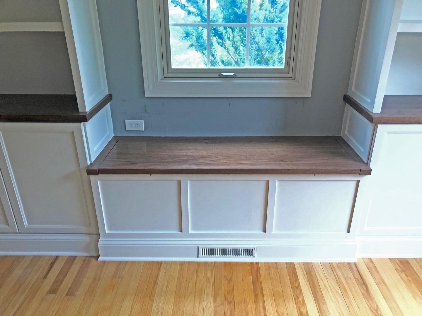  The window seat creates a nice seating area with trunk storage below.  The HVAC duct in the before photo has been relocated and extended to exit through the new baseboards.   