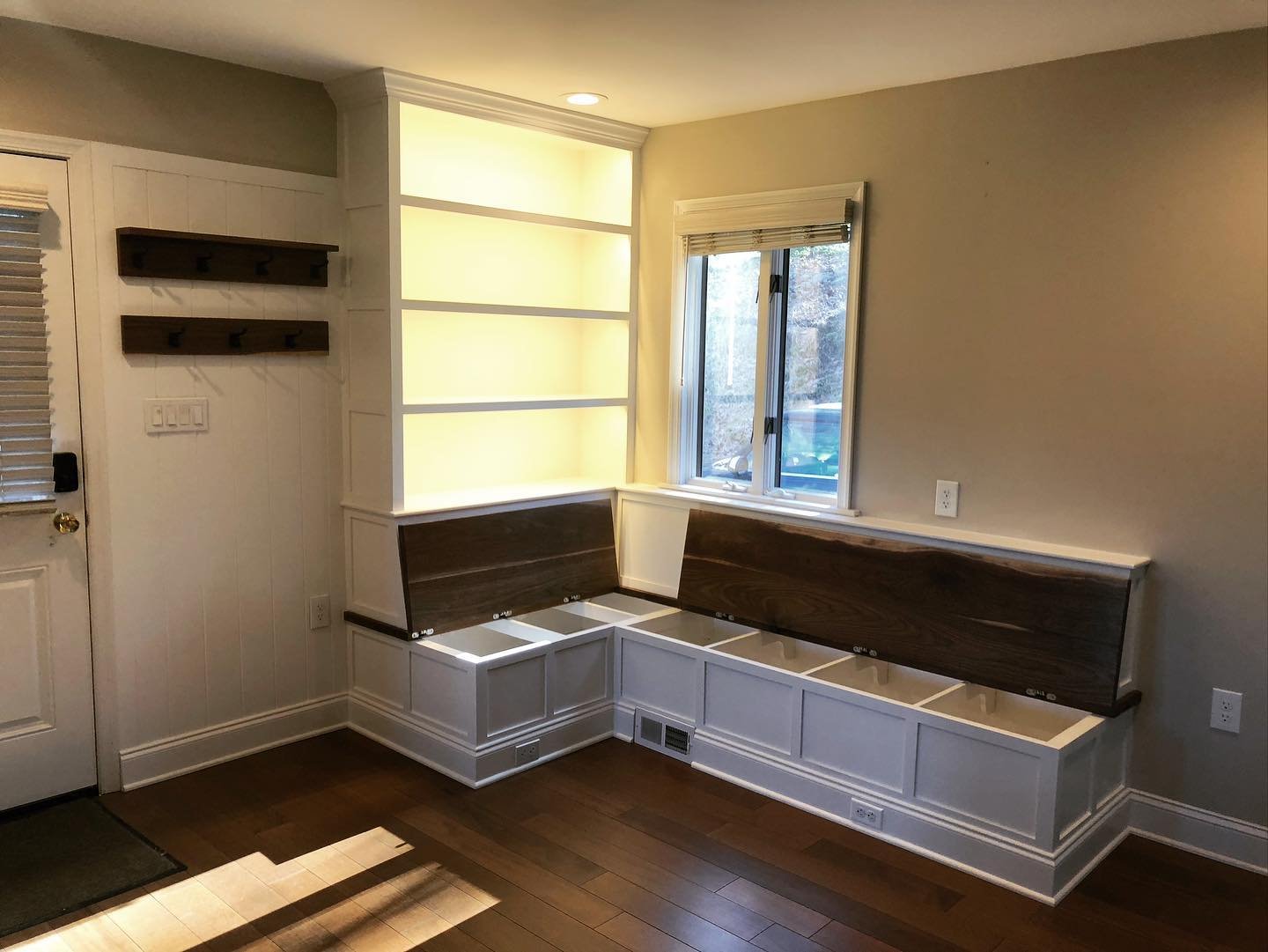  The benchtops open up for additional storage inside the banquette, and under-shelf lighting in the bookshelves provides a nice ambient light for the area.  