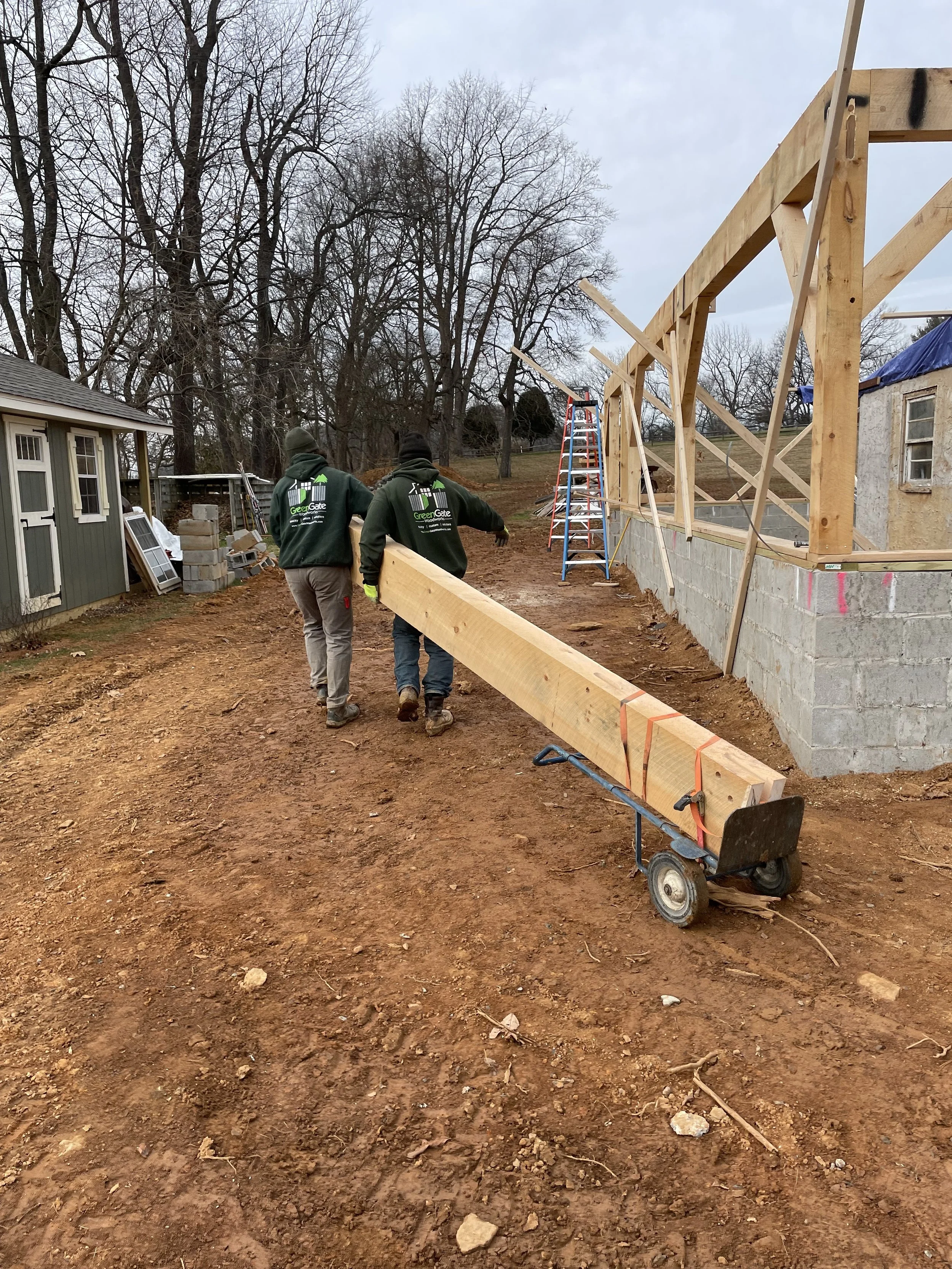  However, since the tractor was tied up with the material lift, we had to muscle the framing pieces to wherever the tractor was. Not fun on a cold somewhat muddy job site, but there was no room in the budget for a second tractor.  