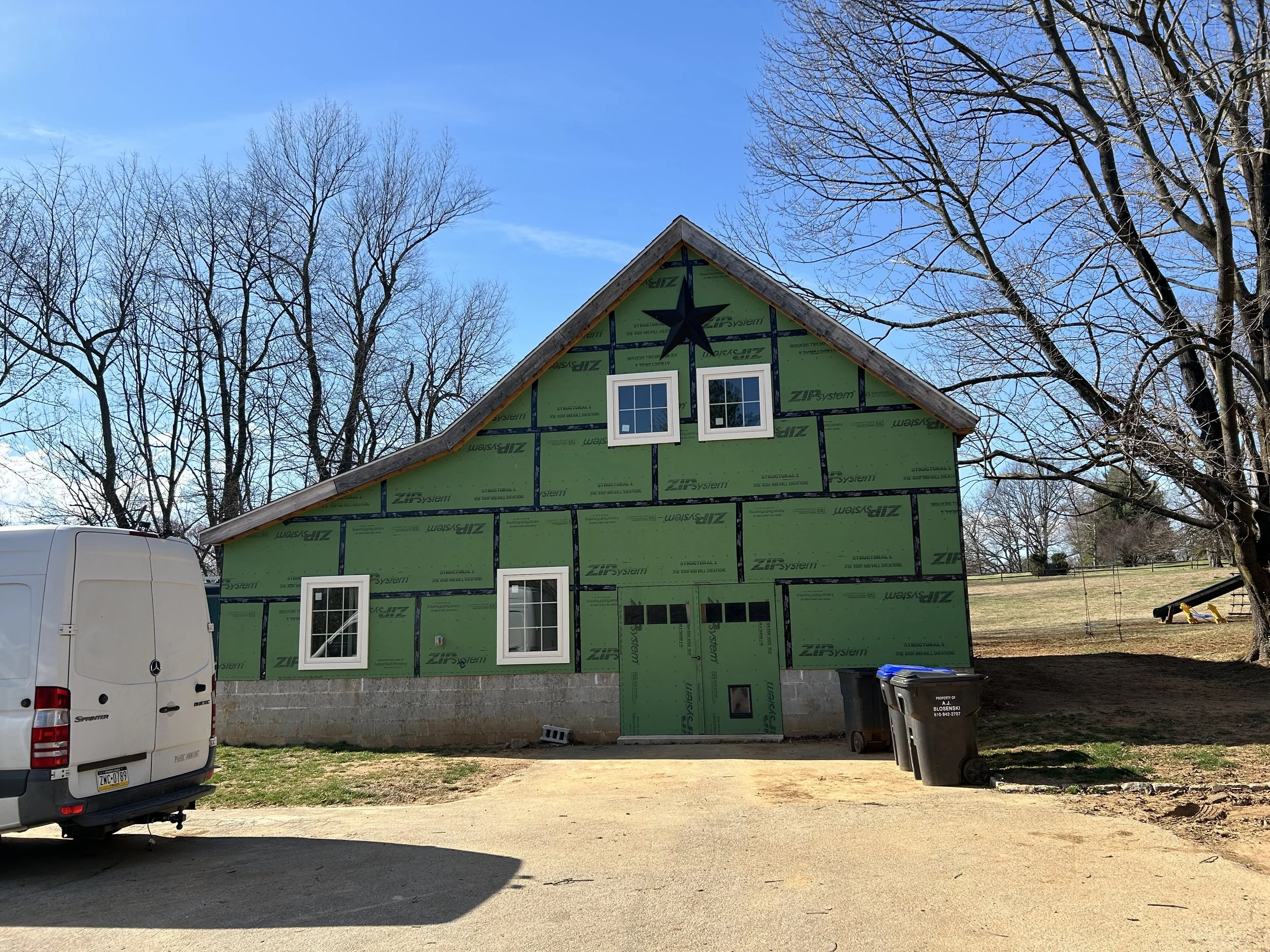  Once the sheathing was installed and taped, everything inside was pretty well protected from the elements and I was able to start installing windows and a pair of temporary doors.  