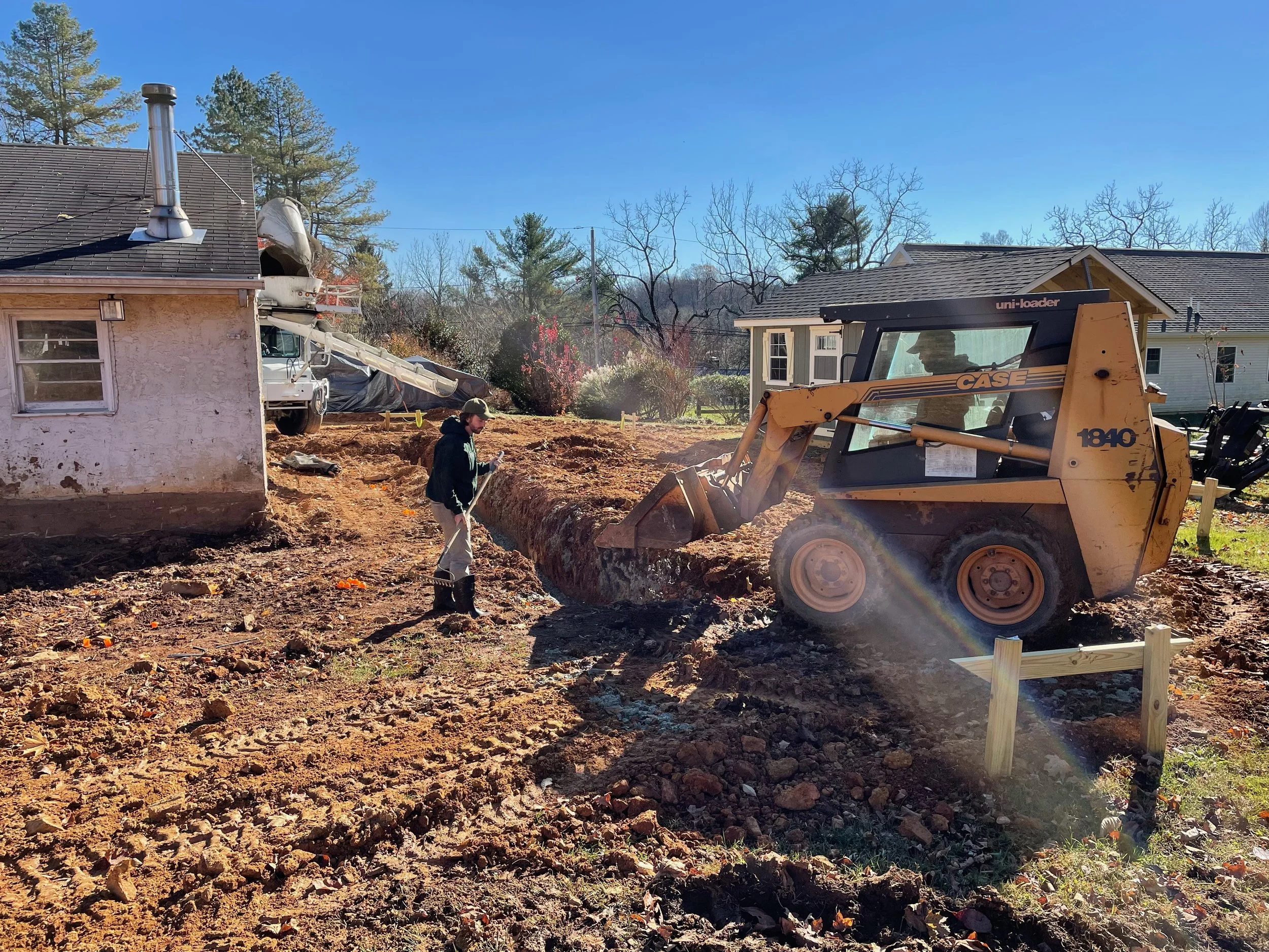  After excavation was complete and rebar was installed, it was time to pour the concrete footers. The skid steer makes short work of pouring the concrete and is far easier than pushing wheelbarrows around.  
