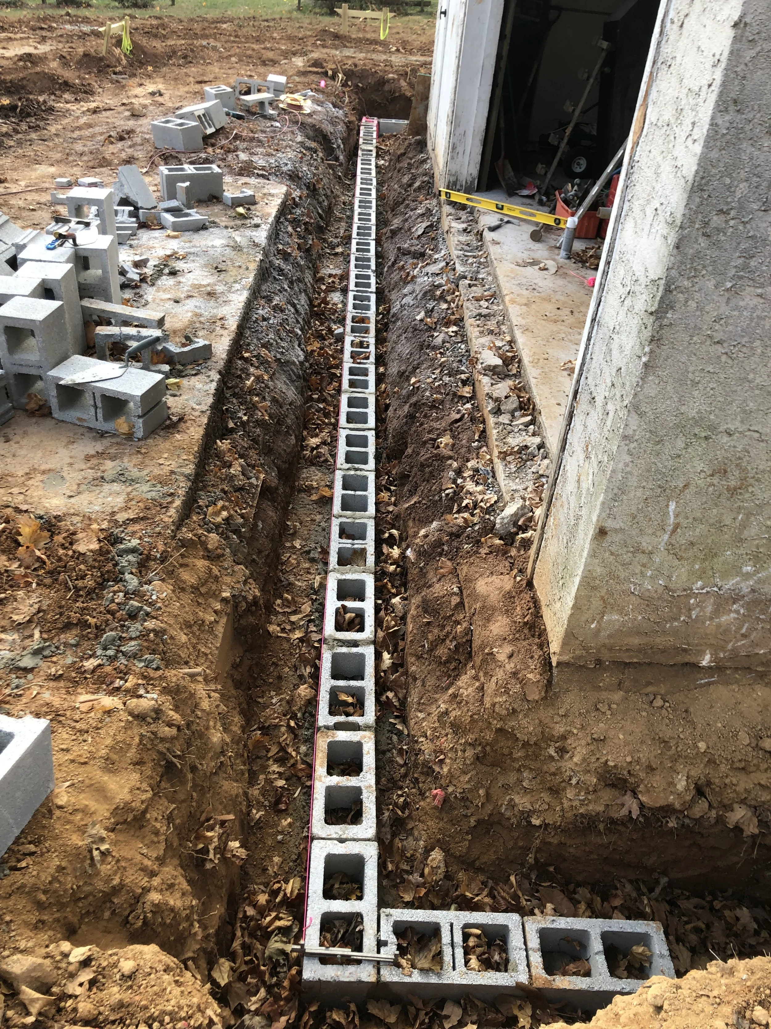  Once the footers were dry, I was able to start laying the first course of cinder blocks for the new foundation walls.  
