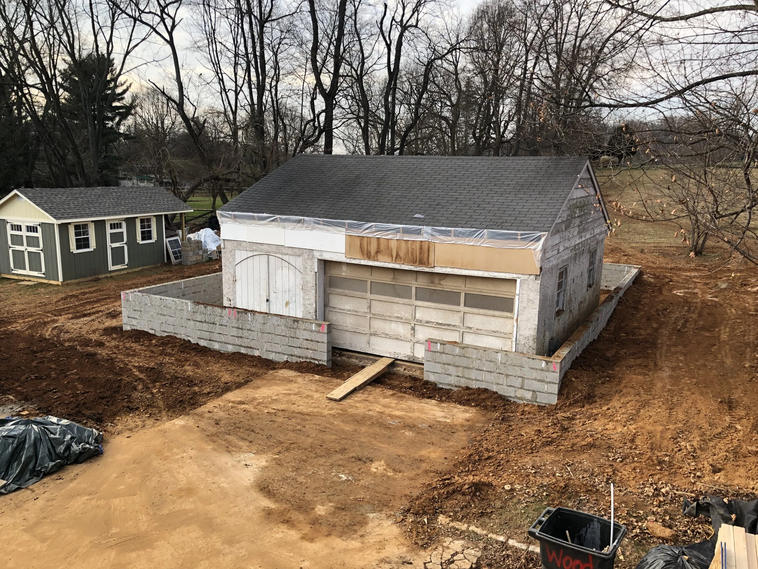  After many hours of masonry that made me appreciate my woodworking job more than ever, the new foundation walls were up and surrounding the old shop.  