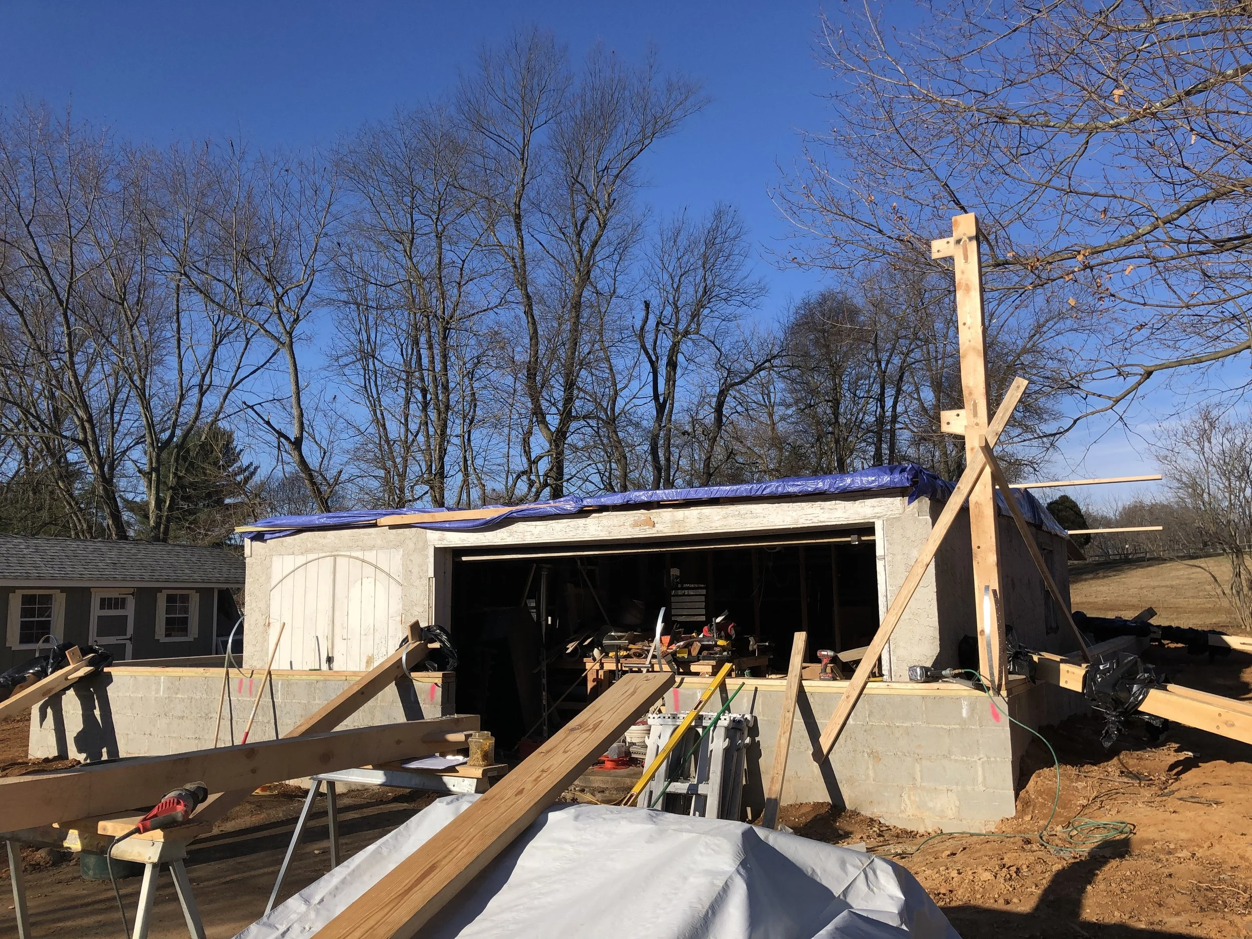  First post going up. Because the new framing had to pass over the shop while still landing at the correct height so the interior stairs would lay out correctly, it was important to get this first post set to the exact height required.  