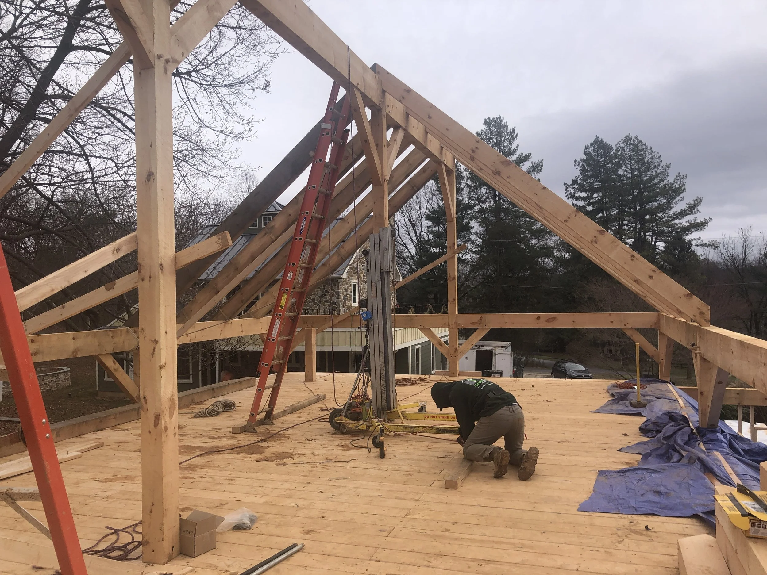  Once the ridge beam was set, we used the material lift to help drag the rafters up into position before securing them in place.  