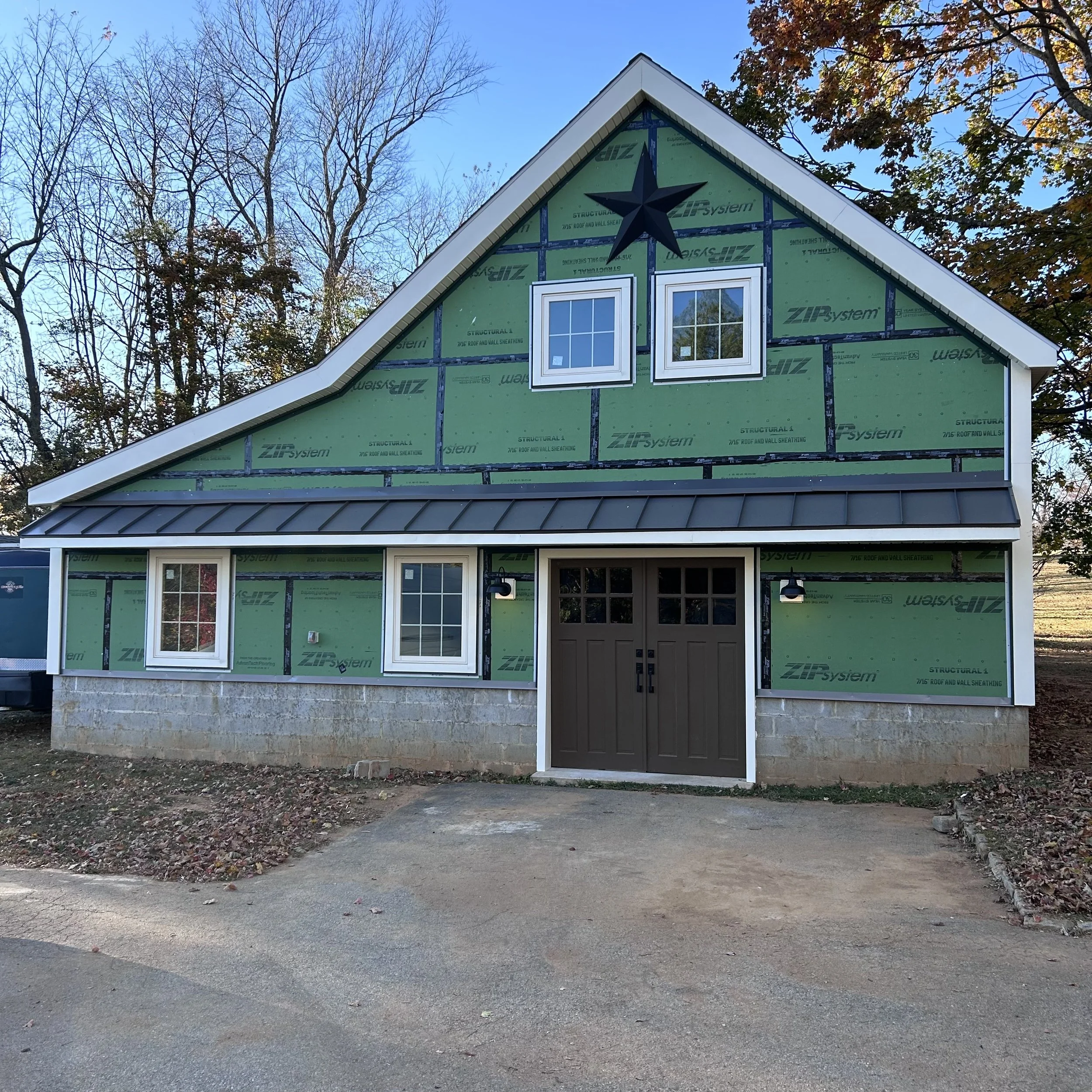  New doors installed, plus capping on the barn is complete and I installed standing seam metal on the pent roof to match the metal roof on our house.  