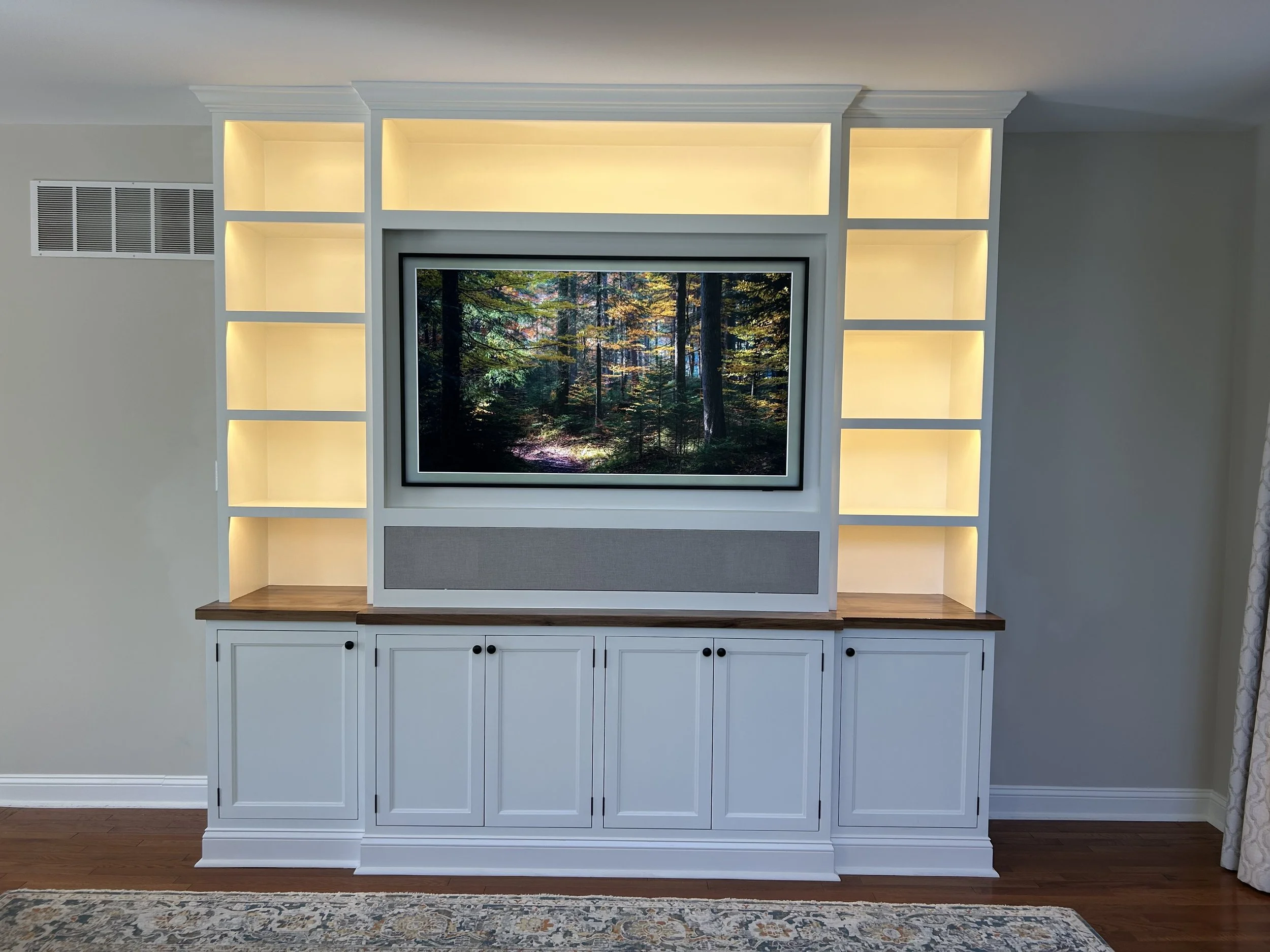  Under-shelf LED lighting provides a warm glow to the room without creating glare on the television.  