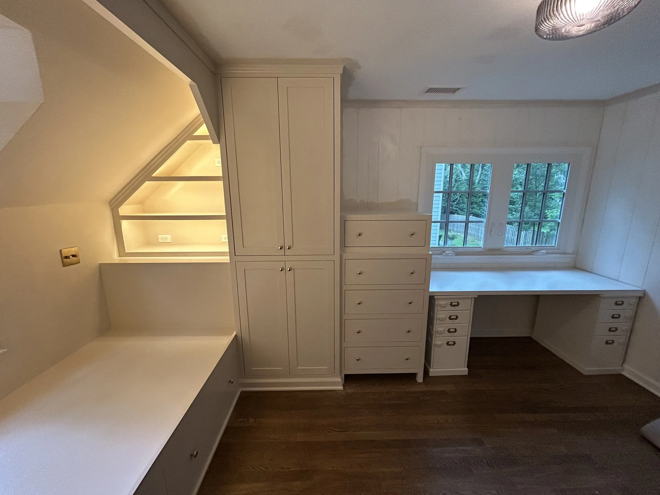  The closet unit consists of an upper hanging area with open storage below. The client was handling painting the walls and ceiling themselves, which is why it’s cut in along the walls but not finished.   