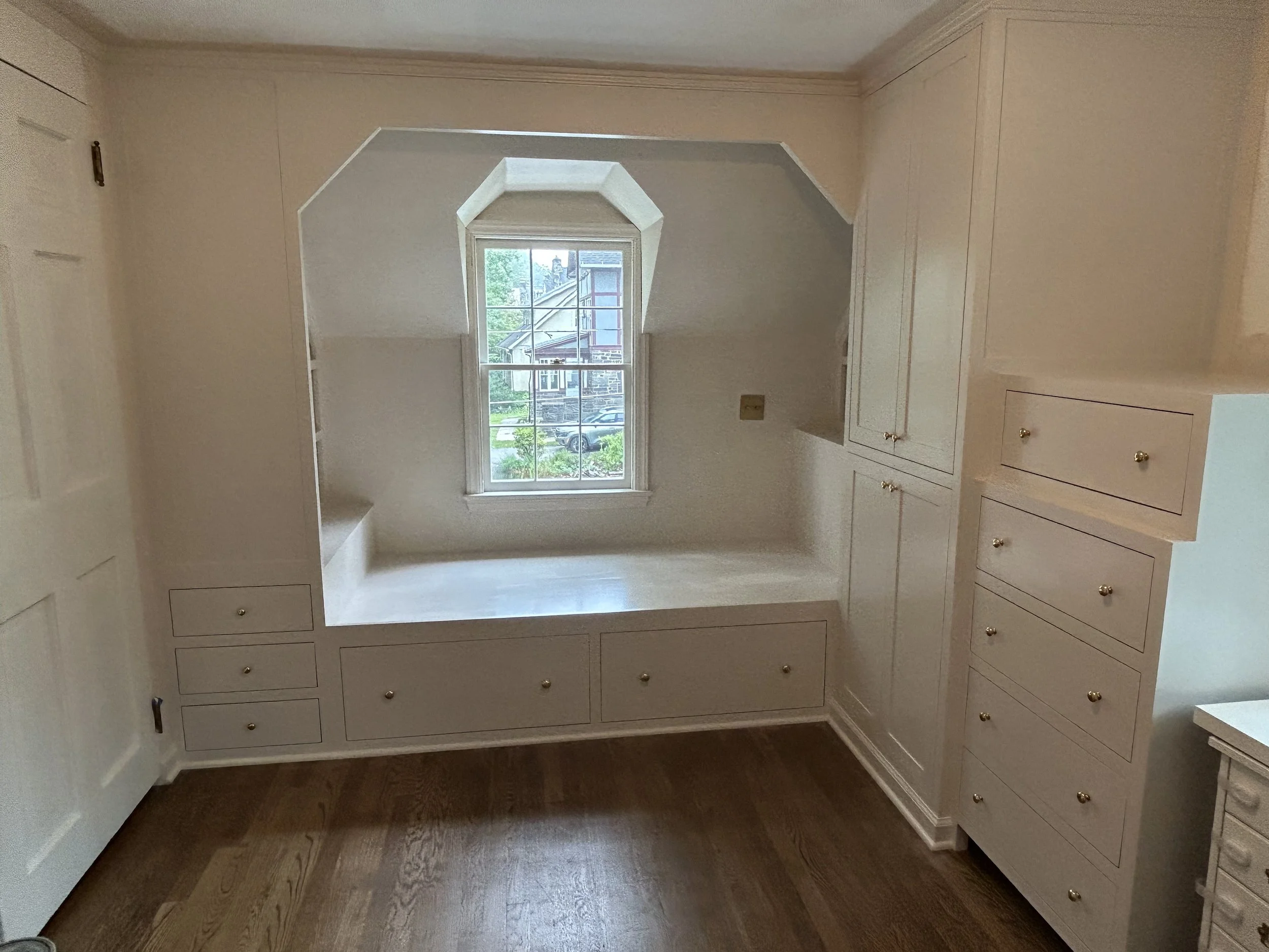  This project consisted of a built-in bed with bookshelves at the foot- and headboards, plus a closet unit, and a built-in dresser. Drawers under the bed and below the footboard provide additional storage.   