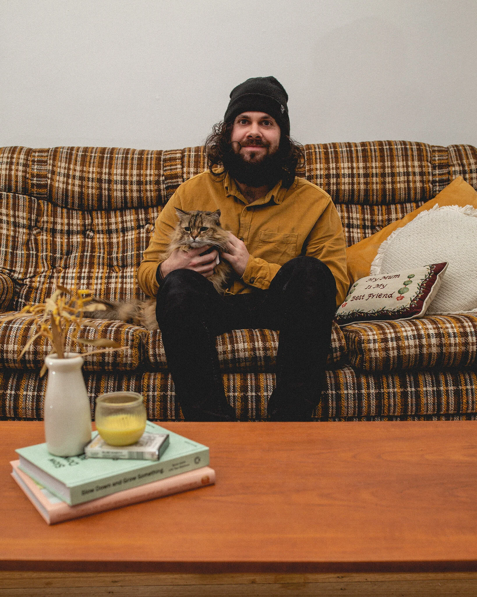 Tasmanian-wedding-photographer-with-a-mustard-shirt-and-cat-on-his-lap