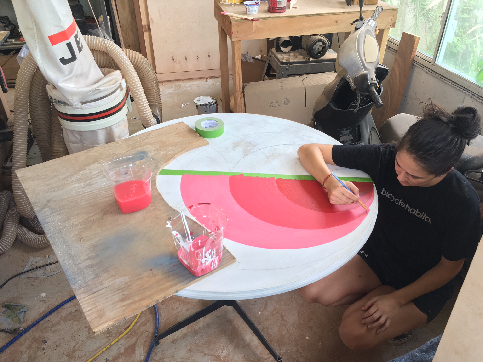 Kristina at work! That green Frog tape works really well. It seems to give a crisper line than regular blue painters tape does.