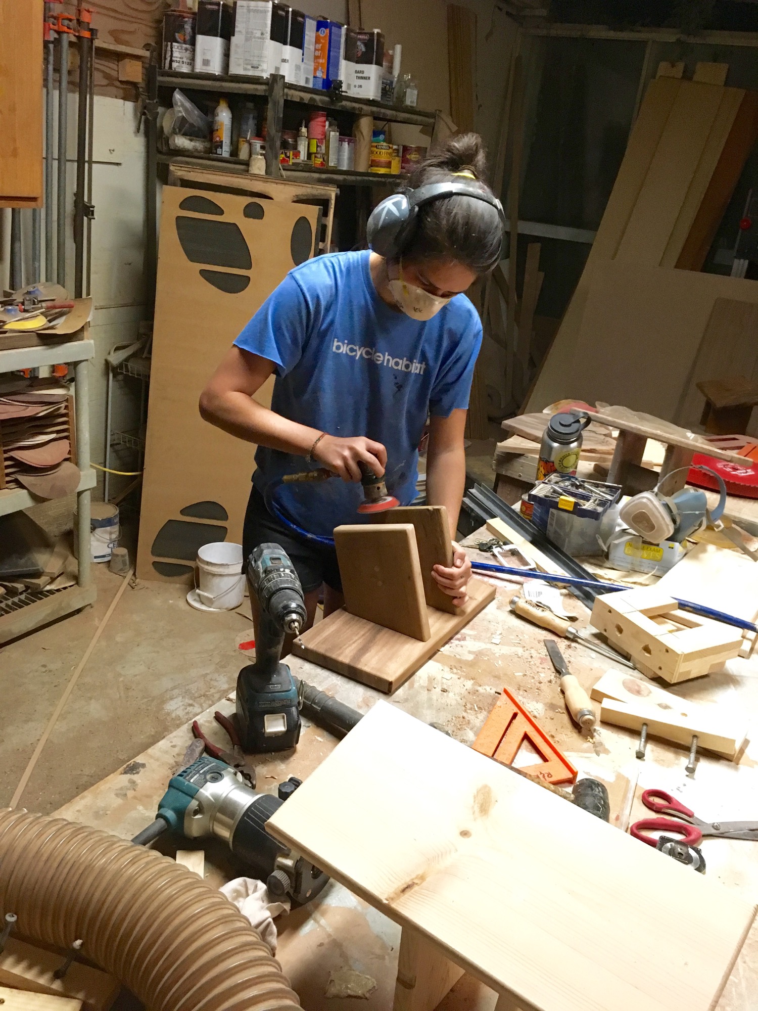  Finish sanding a monkeypod stool using a air-powered detailed sander. 