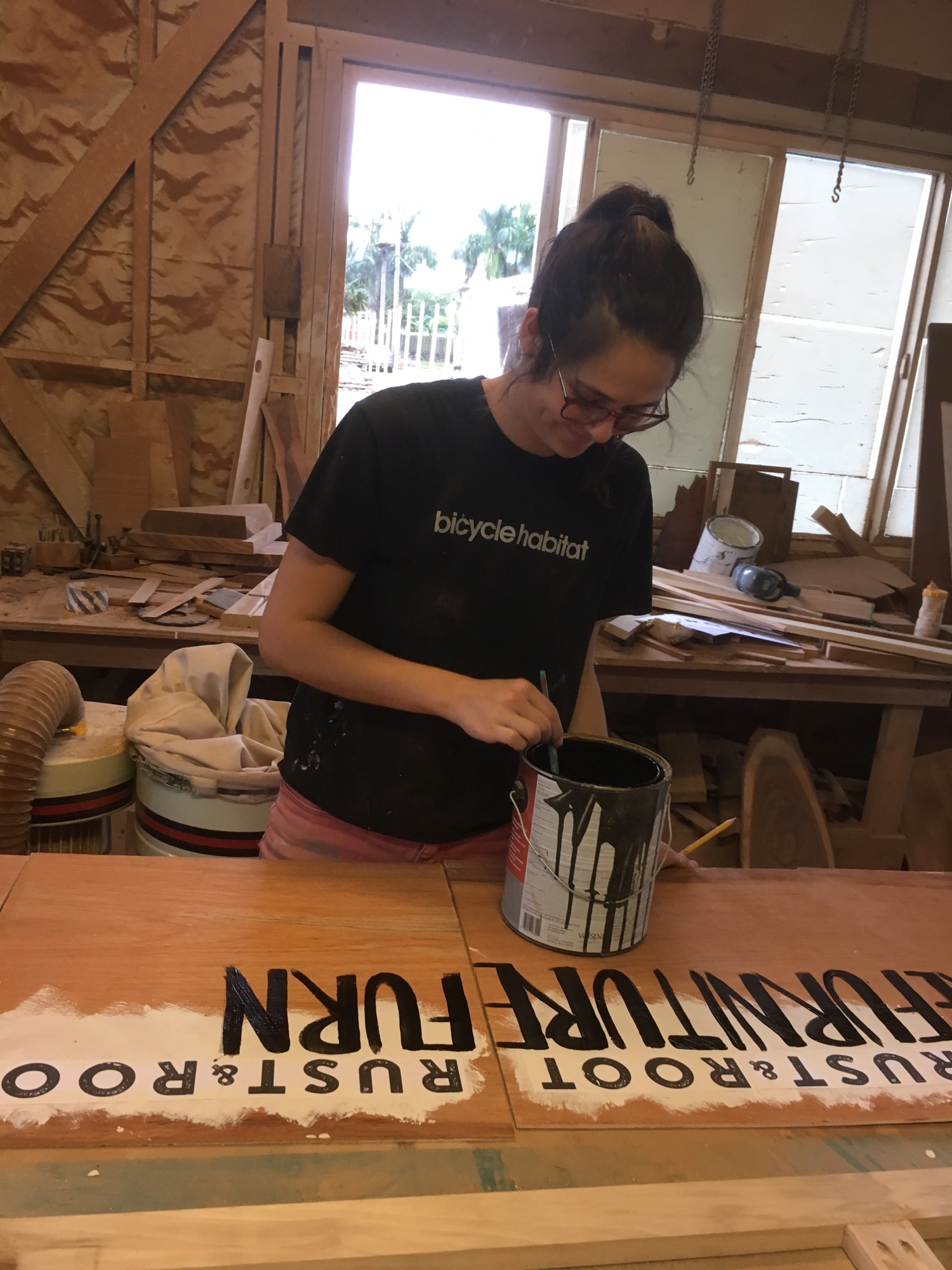 Kristina painting our sale signs