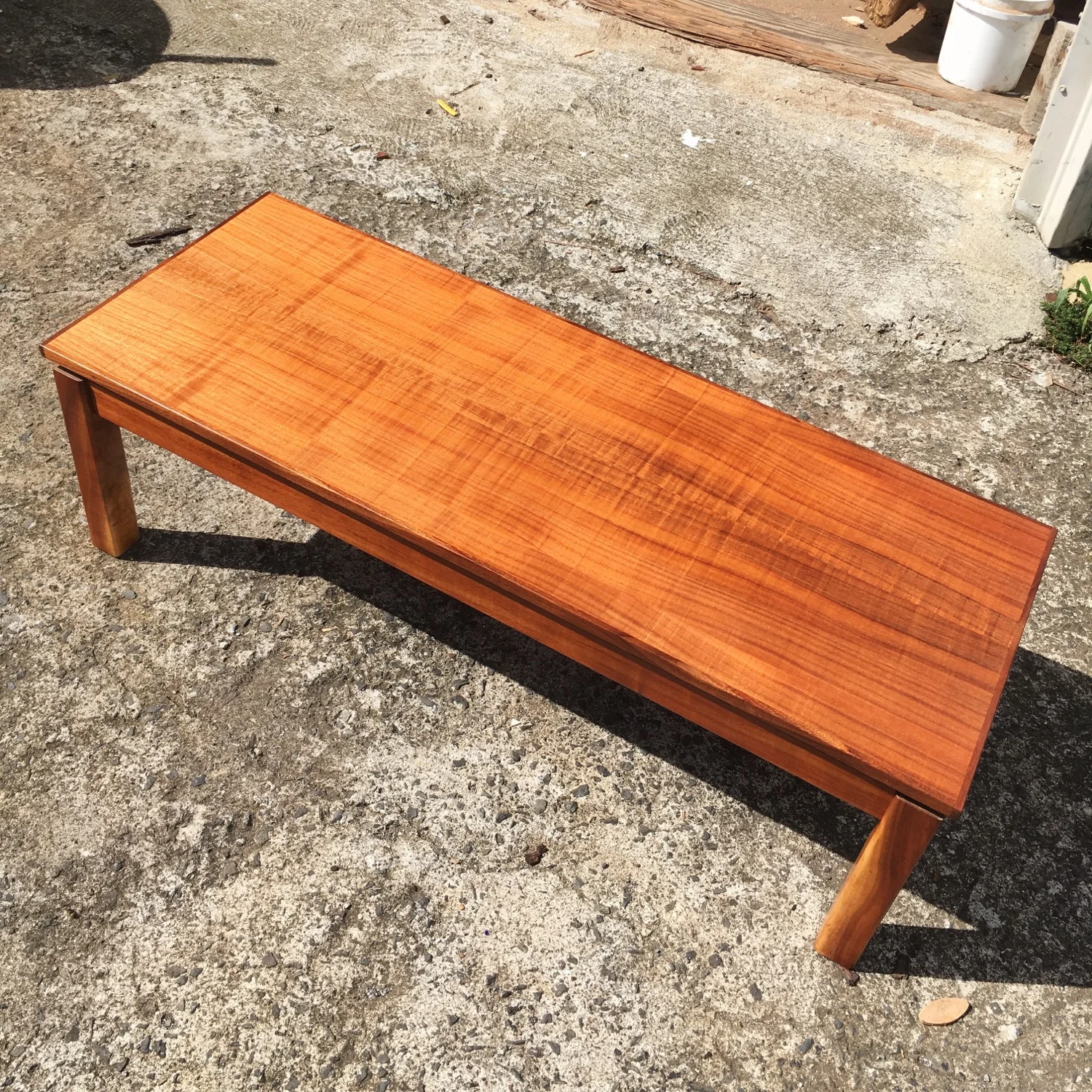 Koa coffee table. Made with curly koa veneer top and solid koa legs.