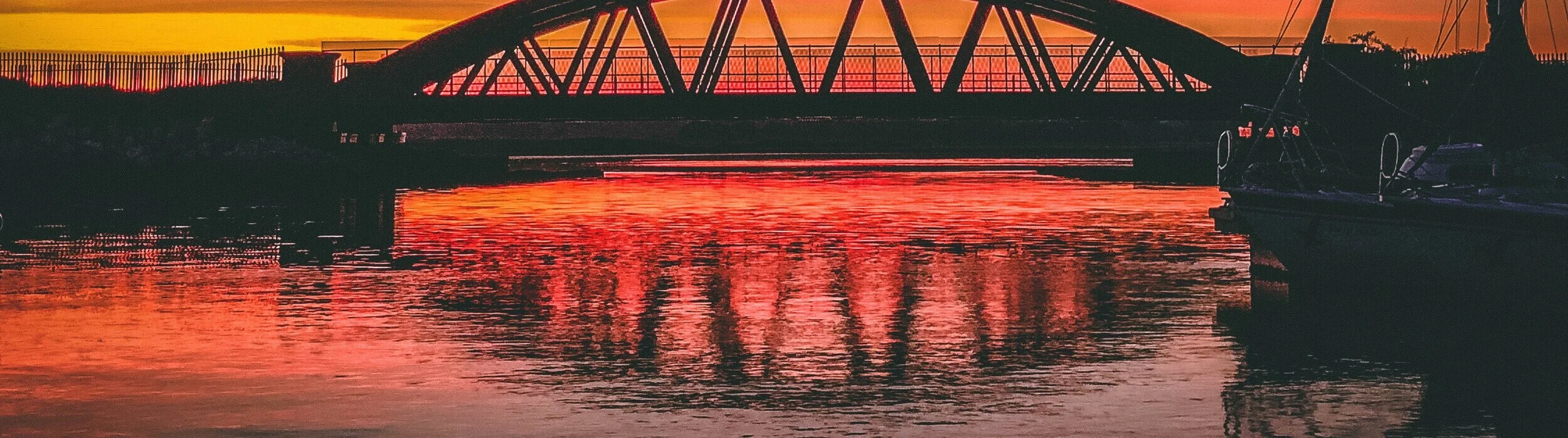Canva+-+Silhouette+Of+Bridge+Under+Orange+Sky.jpg