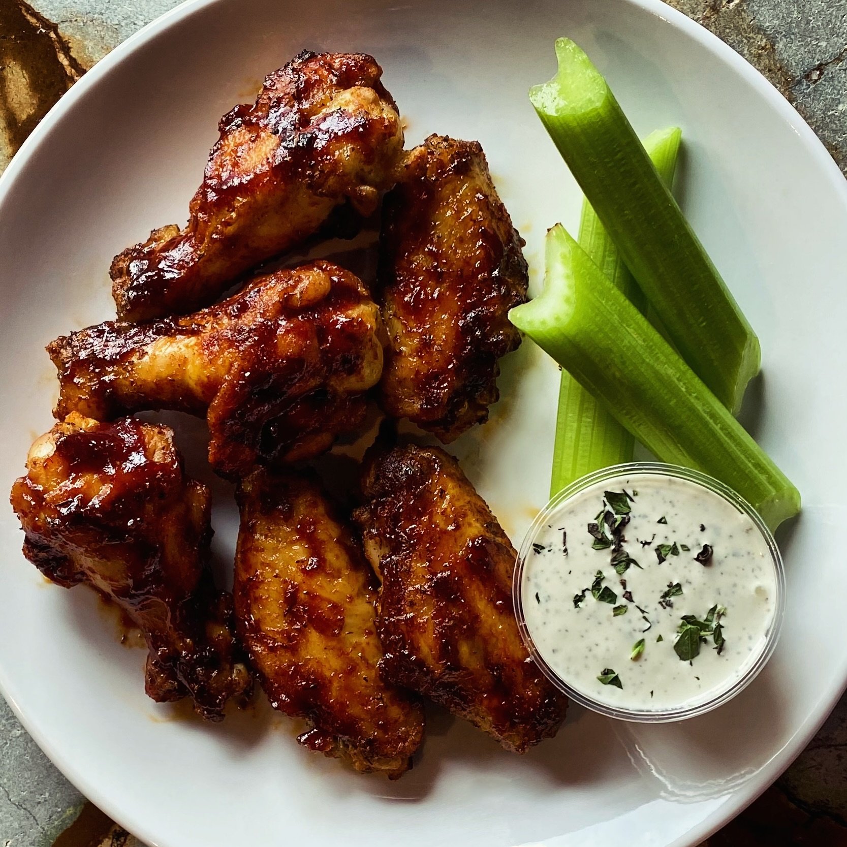 A perfect way to end your day or begin your dinner- our beer-brined wood-fired wings- bbq, buffalo, garlic Parm, jerk or naked -delicious every way! #wingsfordinner #woodfiredwings #wings