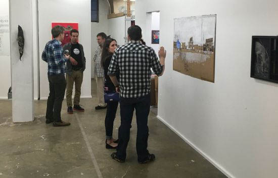 Visitors take in the art at opening night of The Critiqued. Photo for East City Art by Eric Hope.