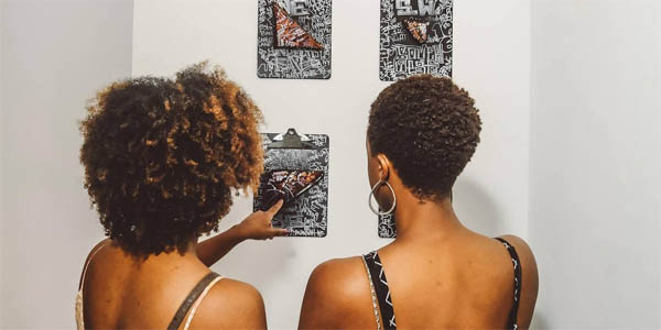 Guests at Prizm Art Fair viewing the artwork of Wesley Clark. 