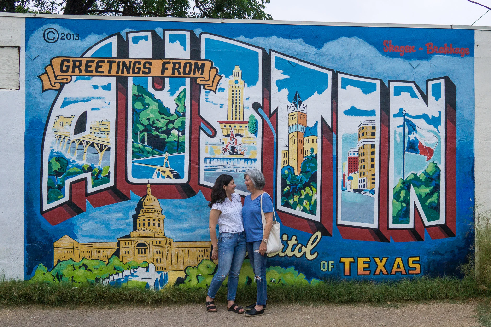 Morgan and her Mom at the Greetings from Austin mural.