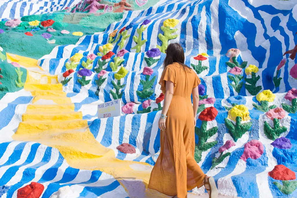 Climbing up the yellow brick road at Salvation Mountain . 