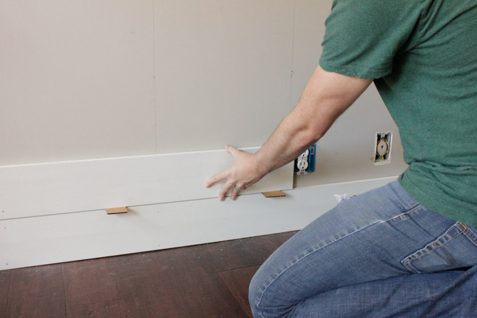 Using cardboard box as a "shim" to create the spacing between each board that we liked. 