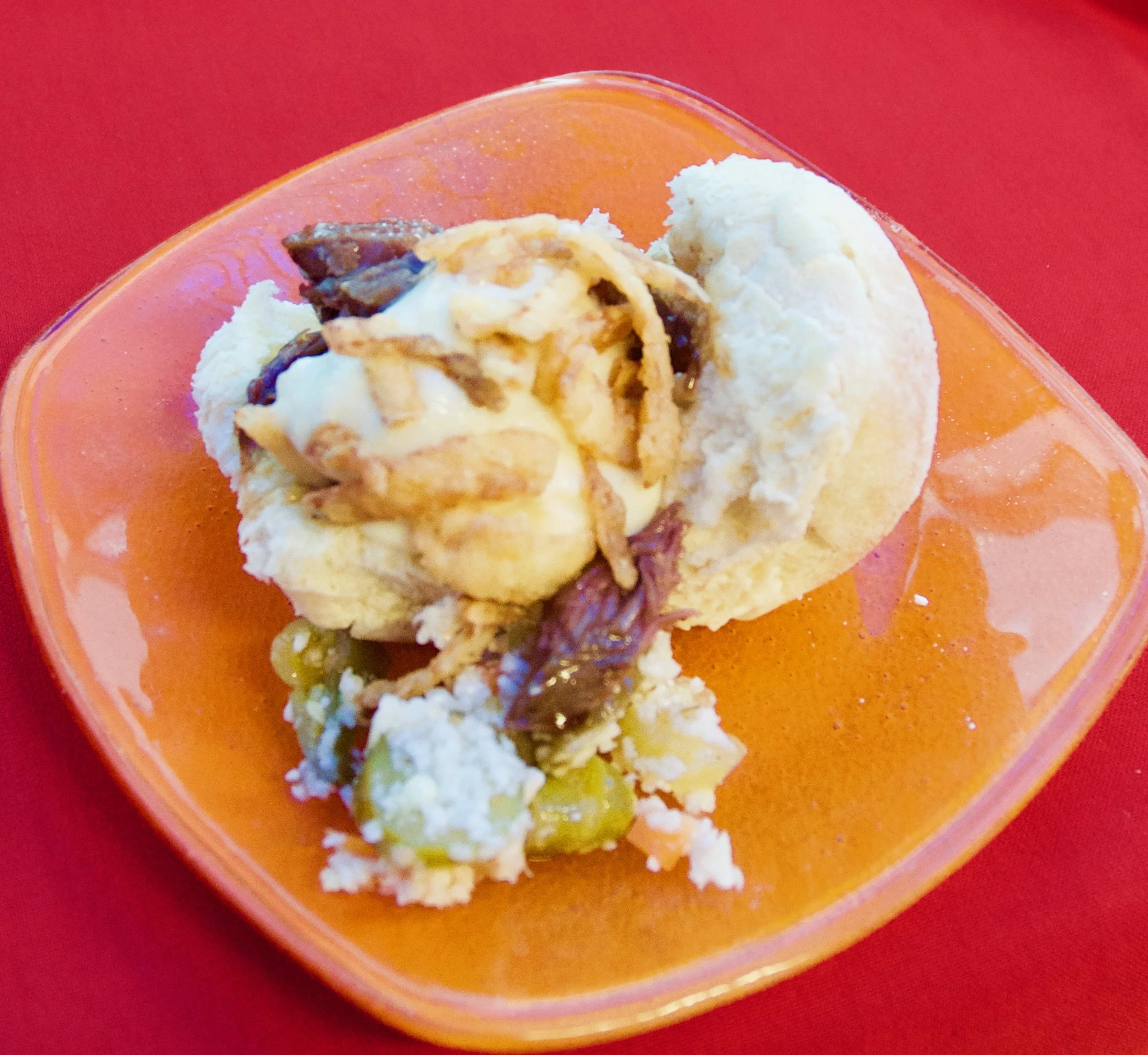 It's hard to pass up the New England lobster roll at the Hops & Barley marketplace, located at The American Adventure. Do try, though, so you can have a go at this New Brunswick slider with horseradish cream and crispy fried onions.
