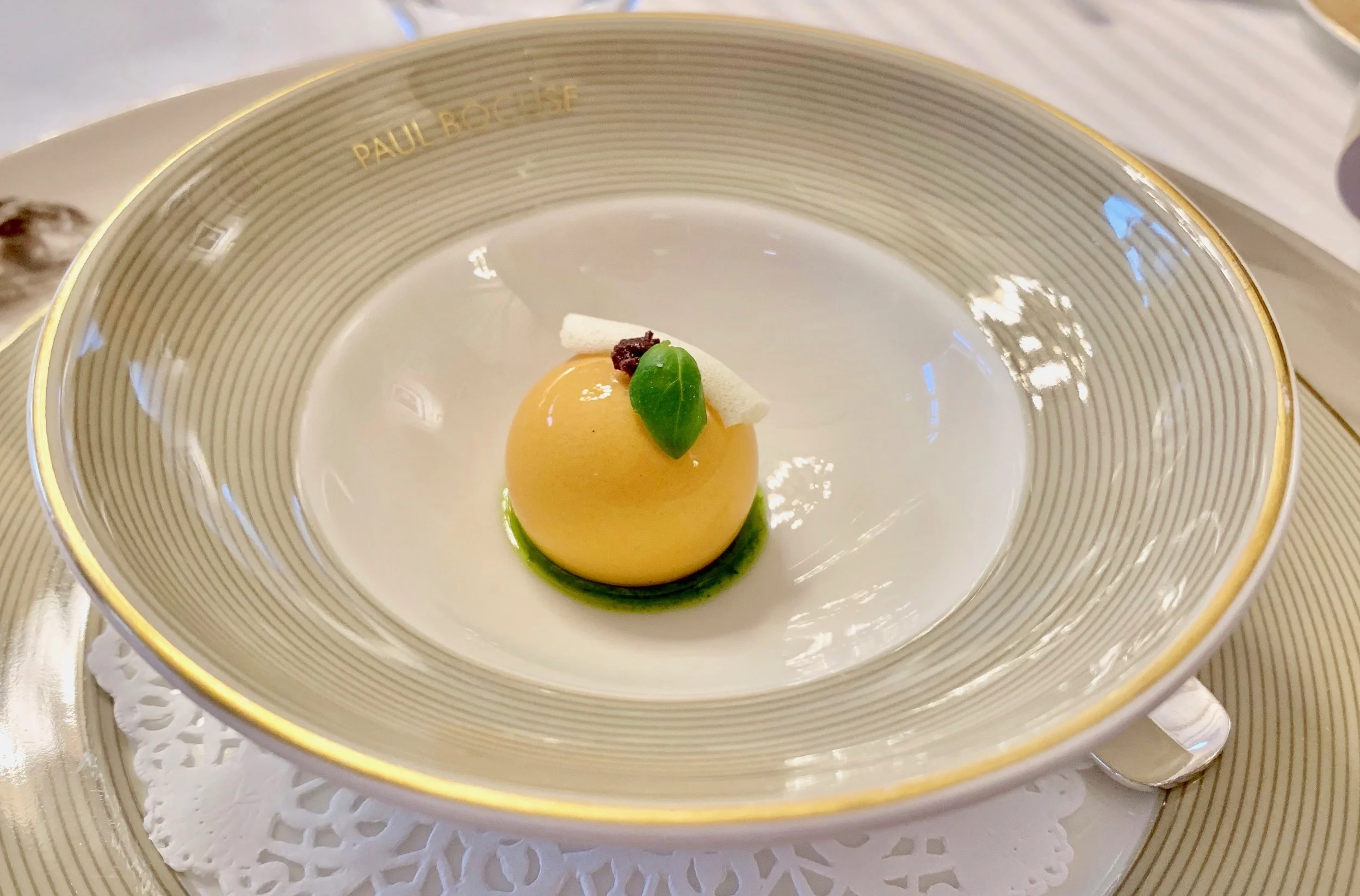 The amuse bouche. Stunning, isn’t it? Notice the inscribed dishes and the silver utensils. I didn’t take notes and don’t remember what this is. Apricot or peach mousse, maybe? Maybe my dining companions will remind me.