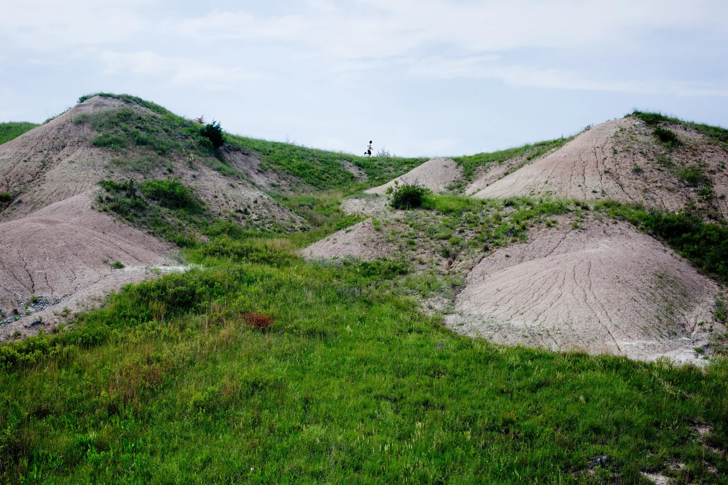  Jeremy runs between his two favorite hills near his relatives' house on the Rosebud Indian Reservation during a break in a summer rodeo camp. 