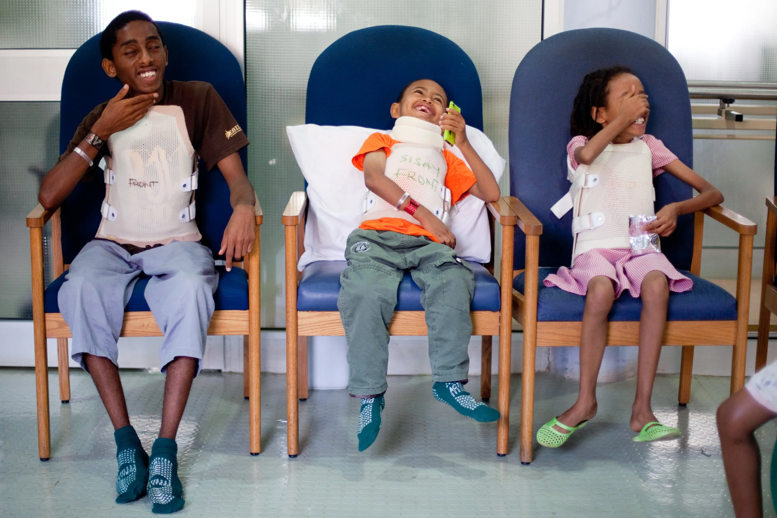  Sisay laughs with other recovering spine patients during physical therapy. 