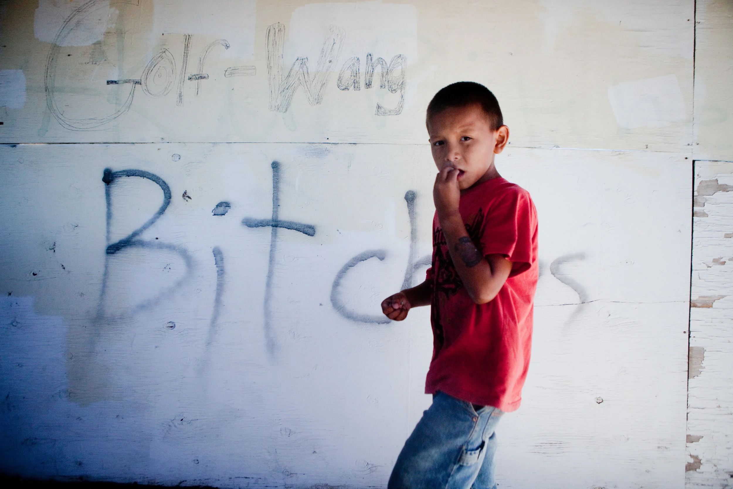  TJ Swift Hawk, 7, walks by graffiti on the upper level of the Rosebud fair grounds viewing deck for rodeo events. Swift Hawk was attending the nonprofit Buffalo Jump’s Ride Across Rosebud camp, which taught youth ages 12-22 skills required for horse