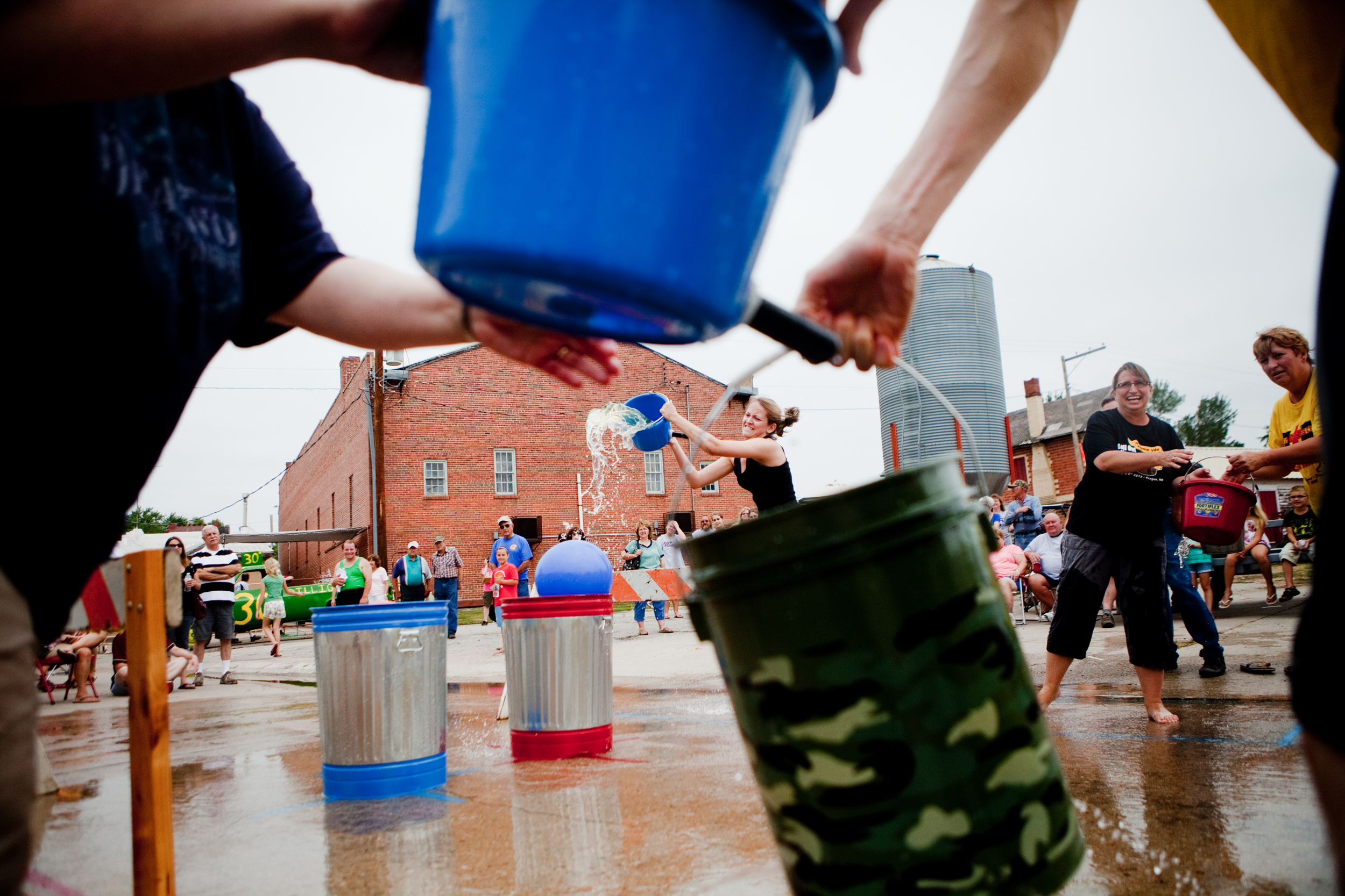 Citizens of Prague, Neb., take part in their hometown-exclusive game called Bohemian water fight, where opposing teams race to fill a bucket with water - and get wet in the process - on July 7, 2012. Prague celebrated it's 125th anniversary July 6-