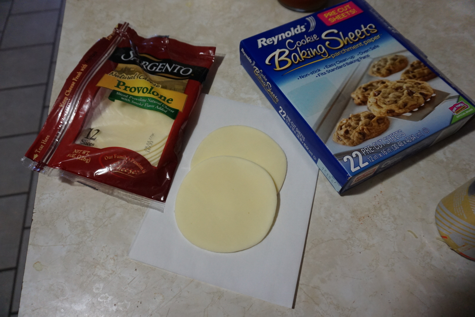 Overlap two slices of Sargento Provolone on a sheet of parchment paper. The parchment paper is a must.
