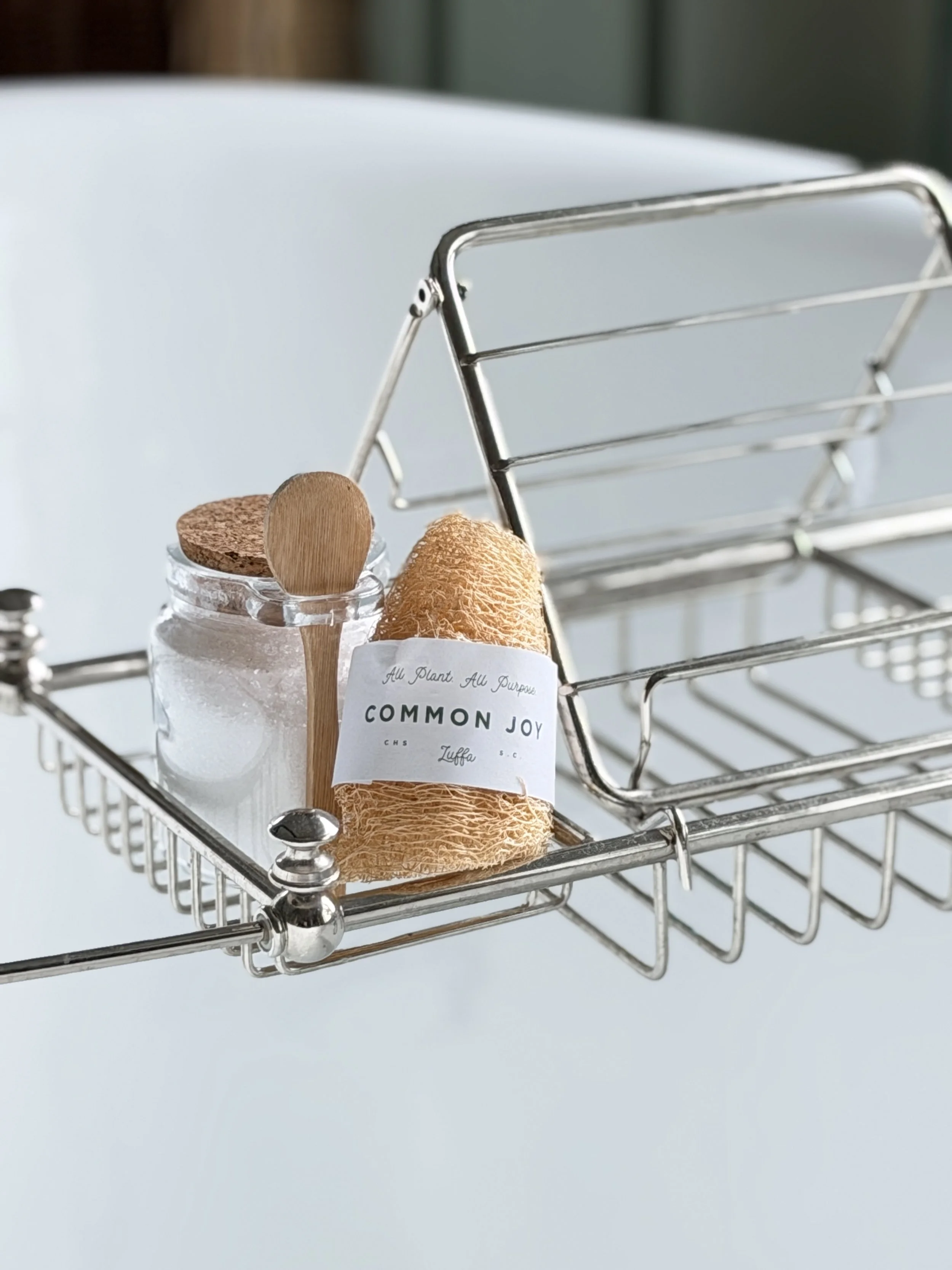 bath salts, loofa on silver bath stand