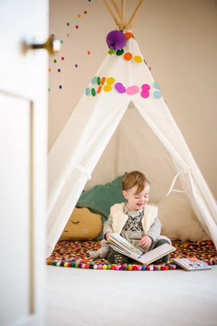 My beautiful Goddaughter having a lovely time with books in her reading den!