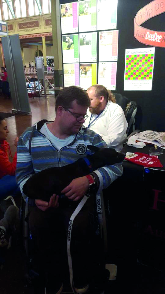 Henri Ling cuddles a hearing dog at the Melbourne Dog Lovers Show last year.&nbsp;