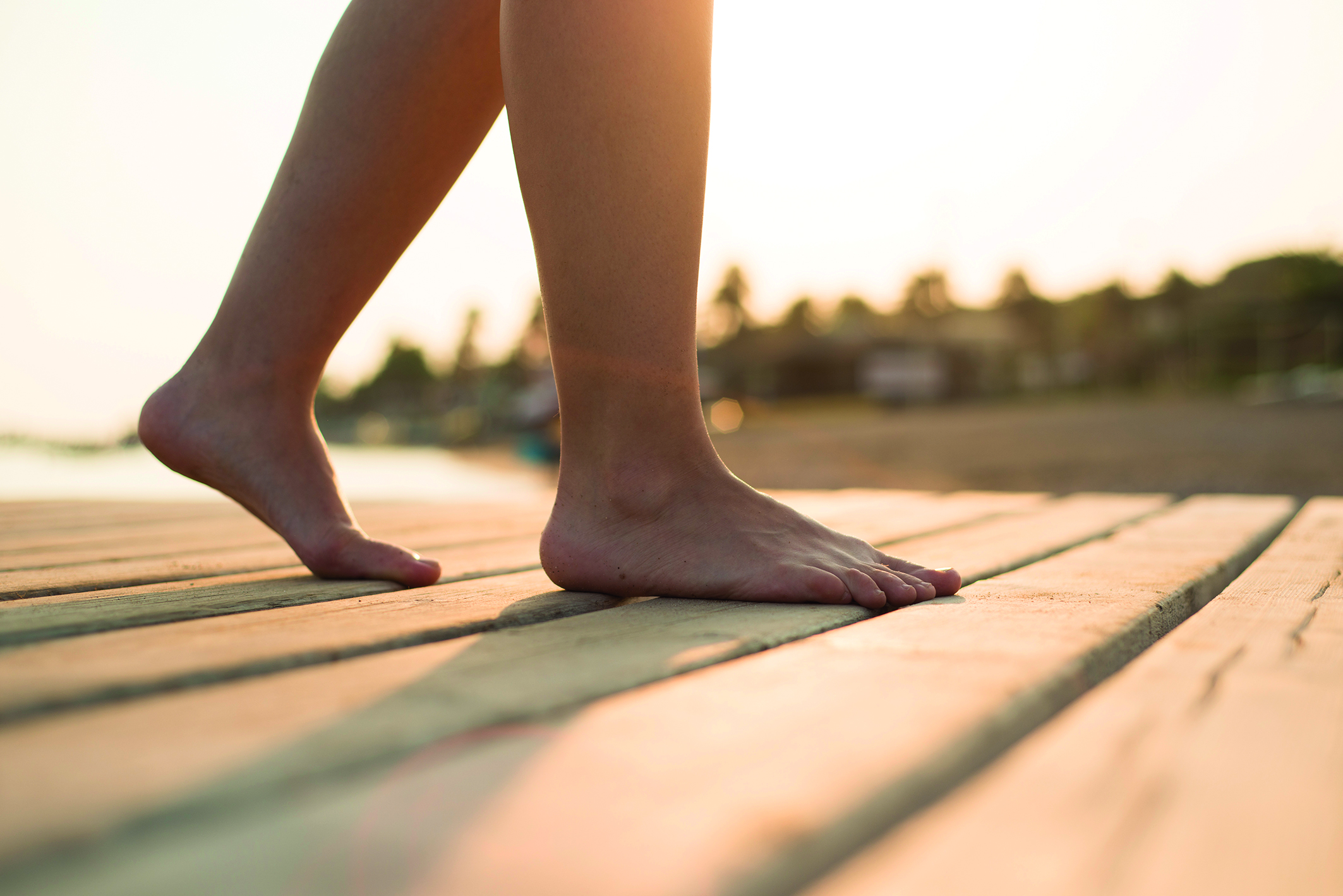 graphicstock-detail-of-female-barefoot-feet-on-sunny-beach_BCfVTBj2--.jpg