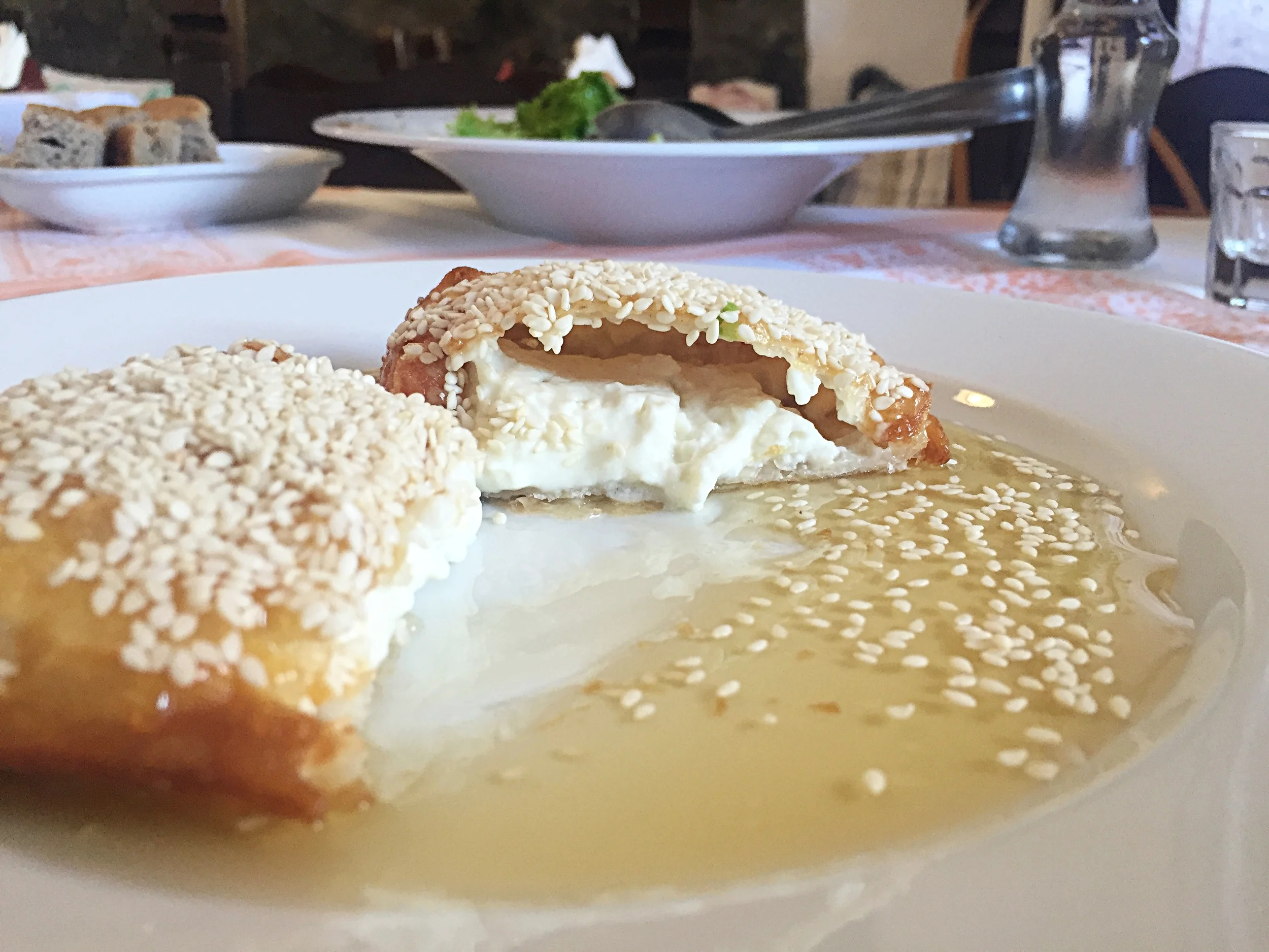 One of my fav dishes: Crisp Baked Dough topped with Sesame, filled with melted feta and drizzle with local honey. Sweet and savory goodness:)